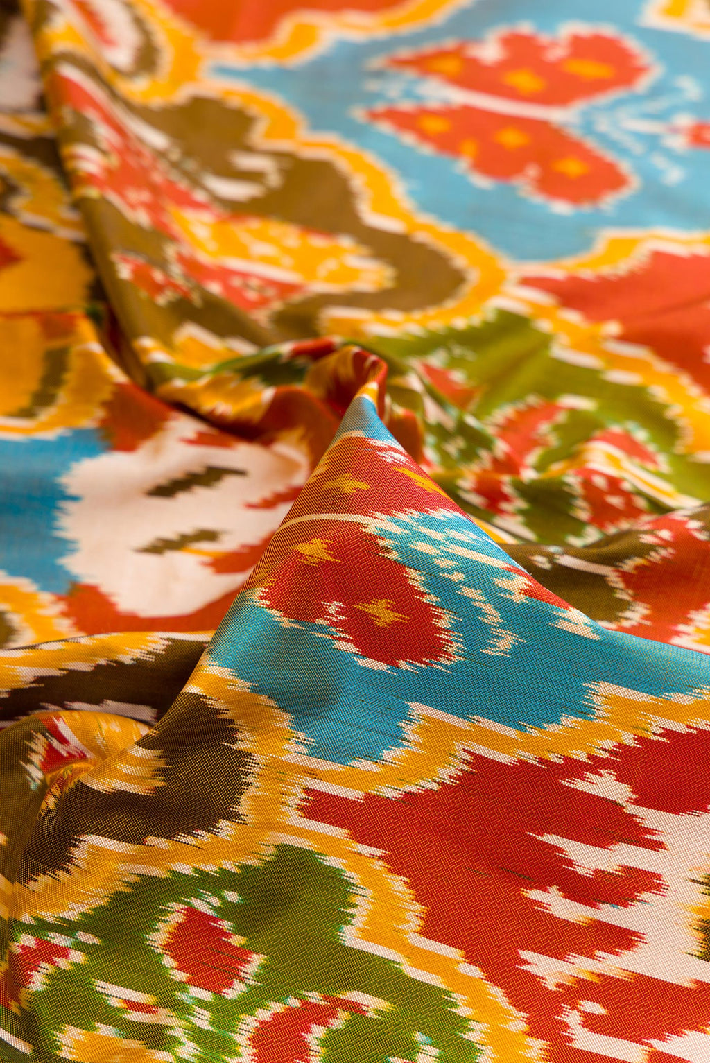 Close up of Pure Silk Mustard Pochampally Saree with Pure Ikat on the body and Ikat Border.  displaying folds
