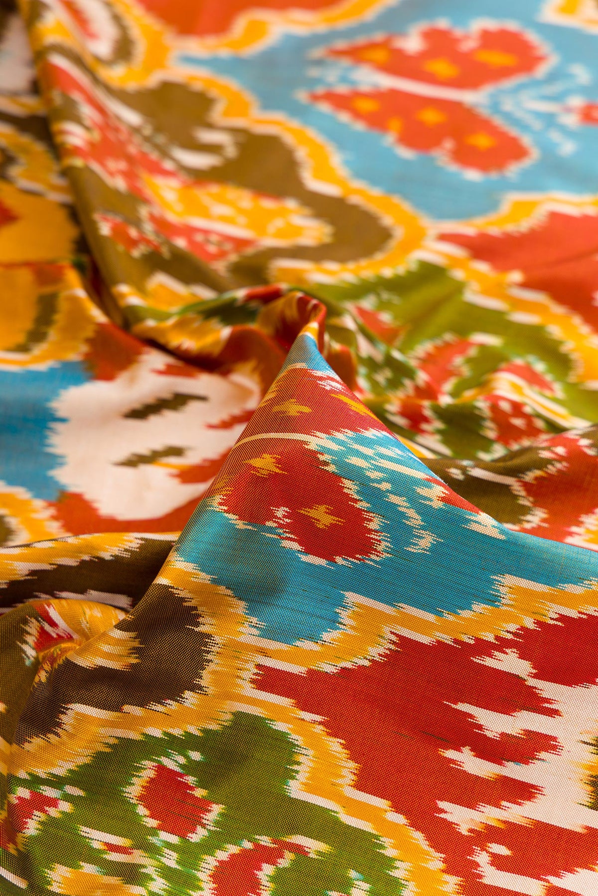 Close up of Pure Silk Mustard Pochampally Saree with Pure Ikat on the body and Ikat Border.  displaying folds