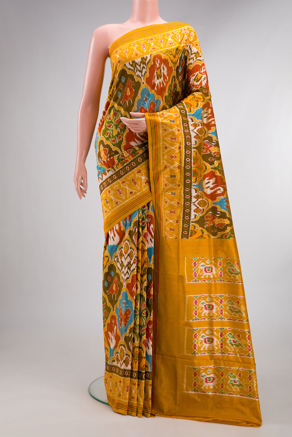 Pure Silk Mustard Pochampally Saree with Pure Ikat on the body and Ikat Border.  displayed on a mannequin