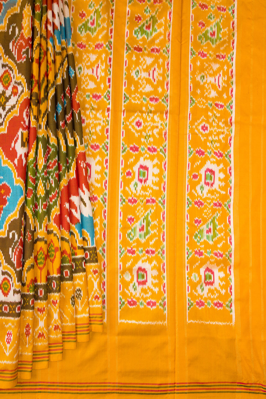 Pleats and pallu of Pure Silk Mustard Pochampally Saree with Pure Ikat on the body and Ikat Border. 