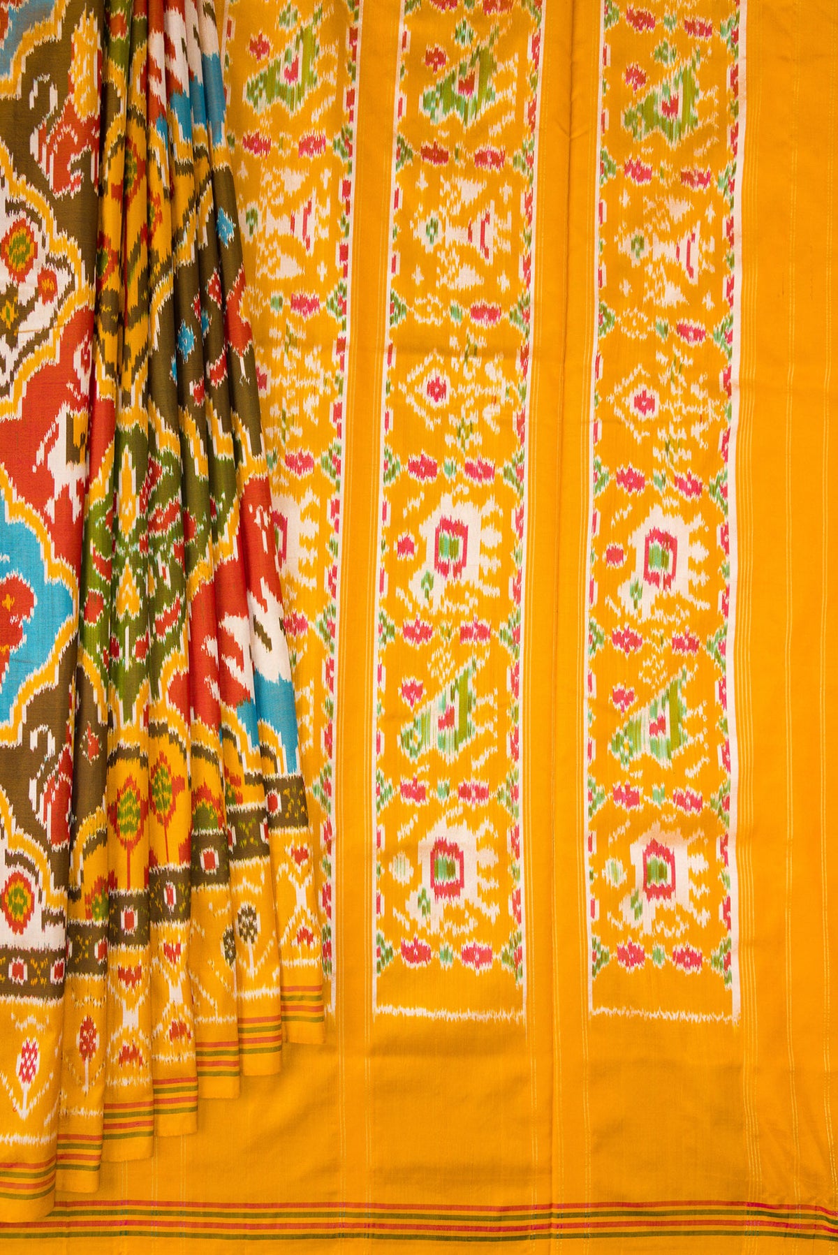 Pleats and pallu of Pure Silk Mustard Pochampally Saree with Pure Ikat on the body and Ikat Border. 