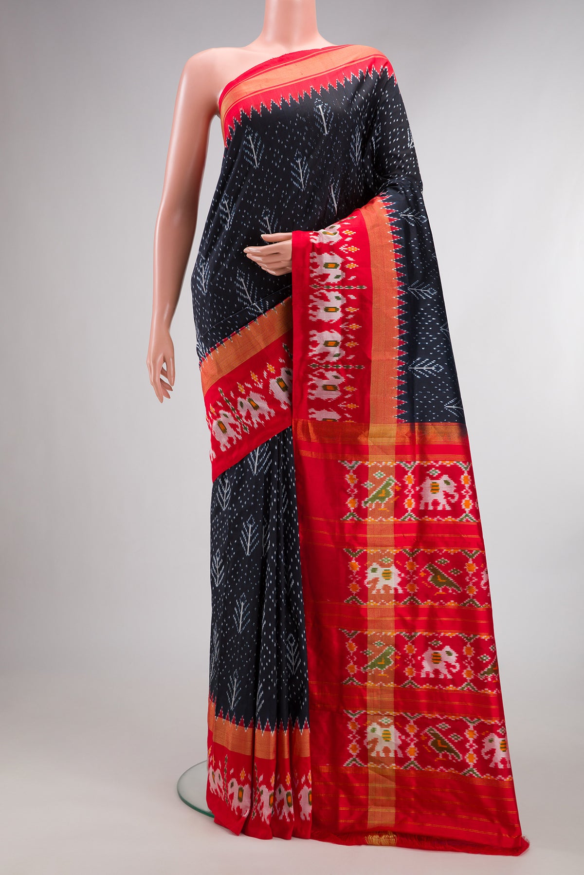 Pure Silk Navy Blue Dual Tone Double Ikat Saree with Ikat Print on the body and Ikat Border.  displayed on a mannequin