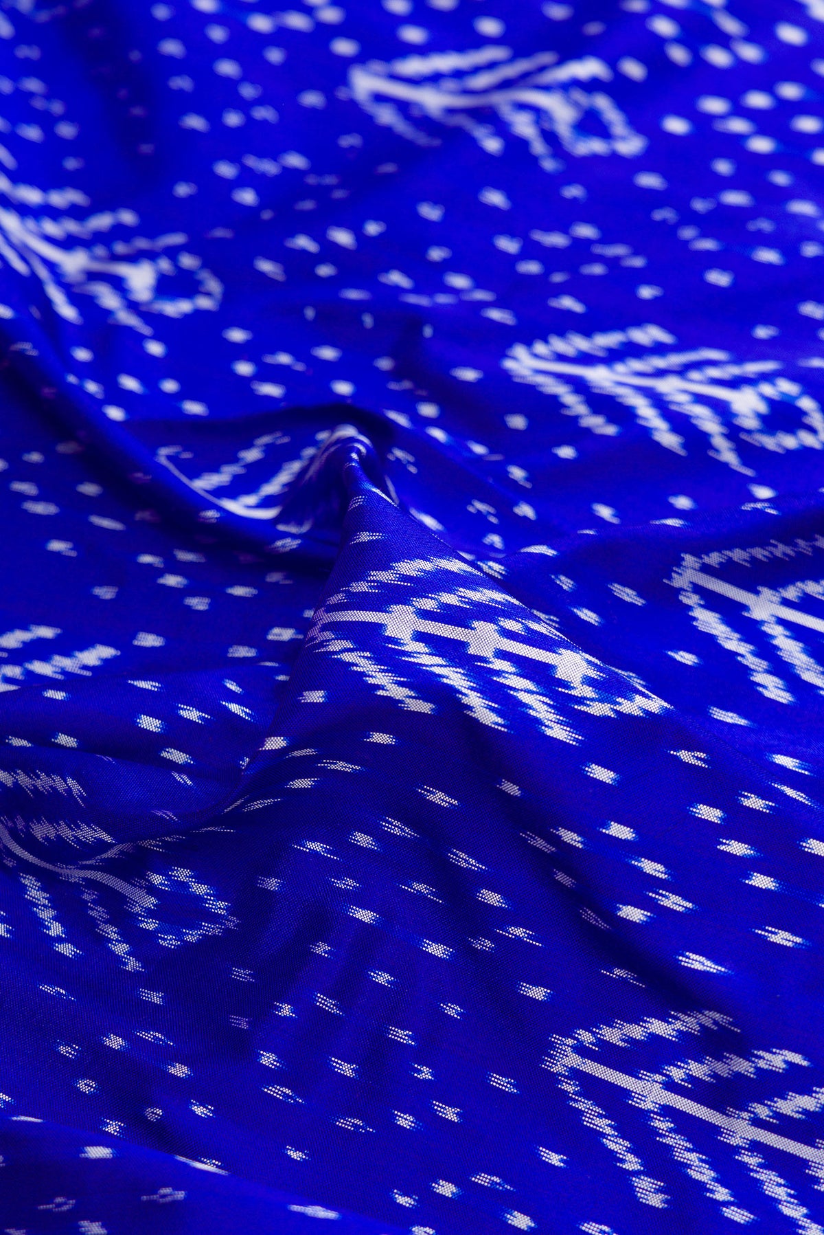 Close up of Pure Silk Royal Blue Pochampally Saree with Pure Ikat on the body and Ikat Border.  displaying folds