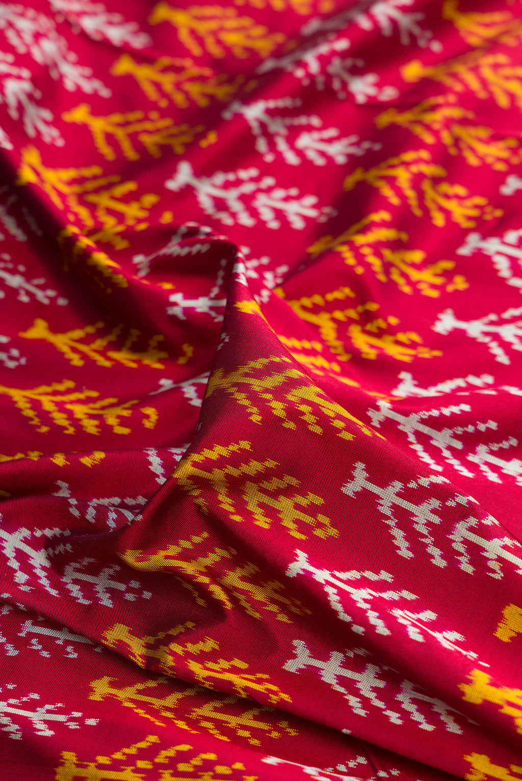 Close up of Pure Silk Deep Red Pochampally Saree with Pure Ikat on the body and Ikat Border.  displaying folds