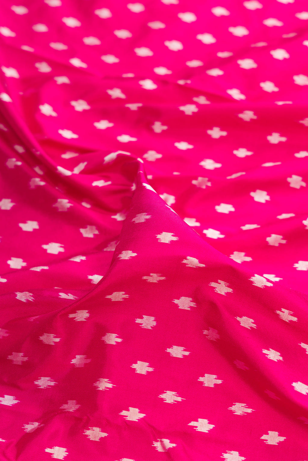 Close up of Pure Silk Dark Pink Pochampally Saree with Pure Ikat on the body and Ikat Border.  displaying folds