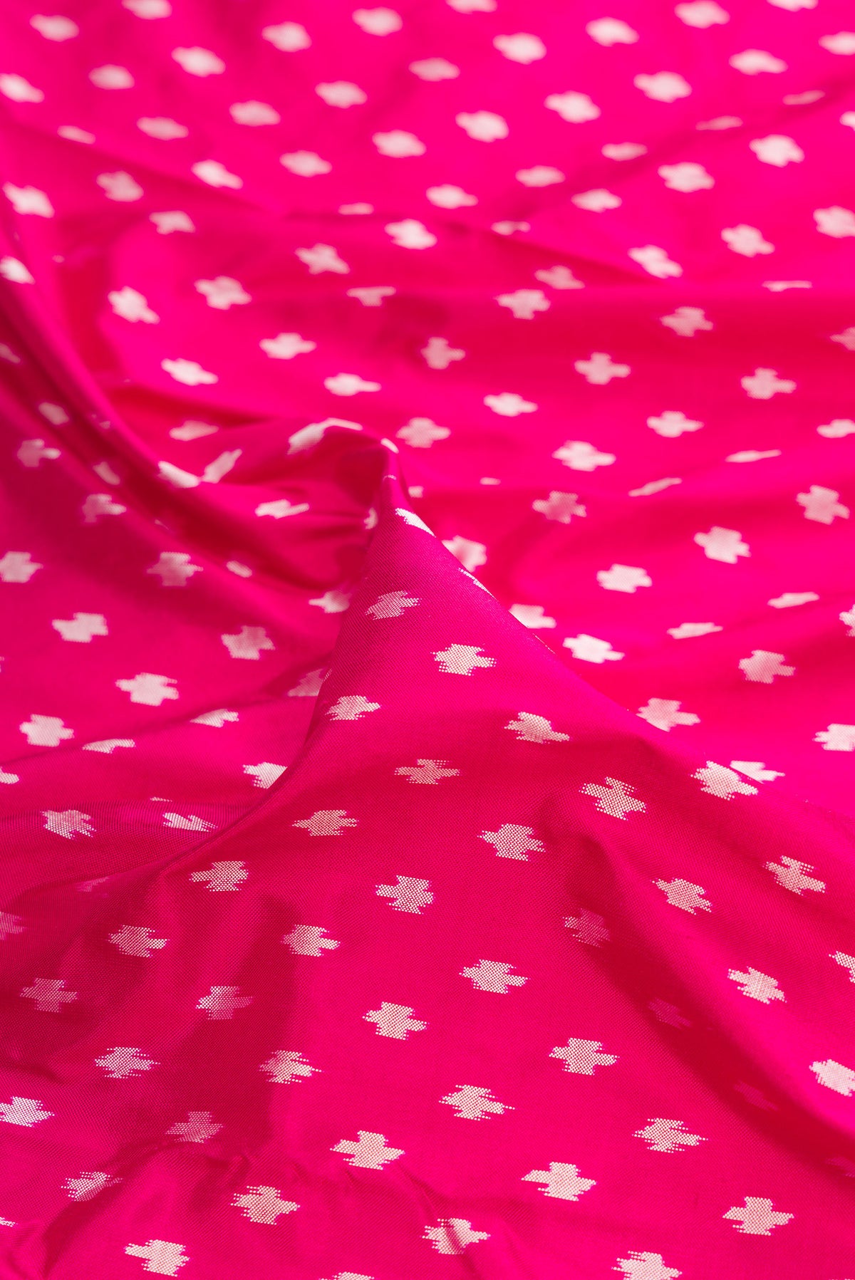 Close up of Pure Silk Dark Pink Pochampally Saree with Pure Ikat on the body and Ikat Border.  displaying folds