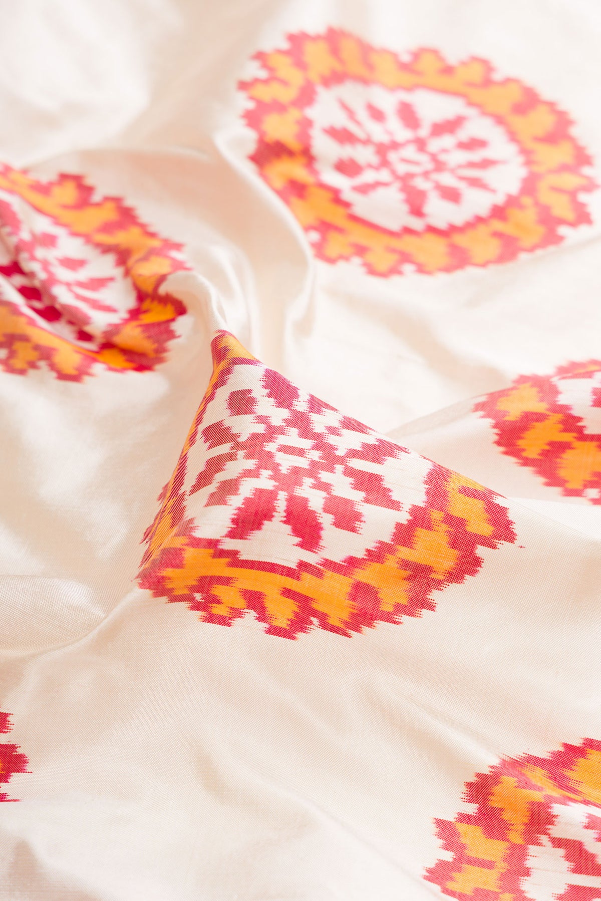 Close up of Pure Silk Off White Pochampally Saree with Pure Ikat on the body and Zari Border.  displaying folds
