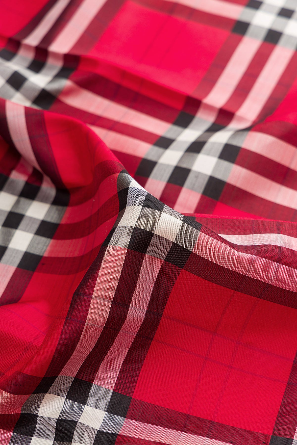 Close up of Pure Silk Multi Color Kanjivaram Saree with Checked design on the body and Plain Border.  displaying folds