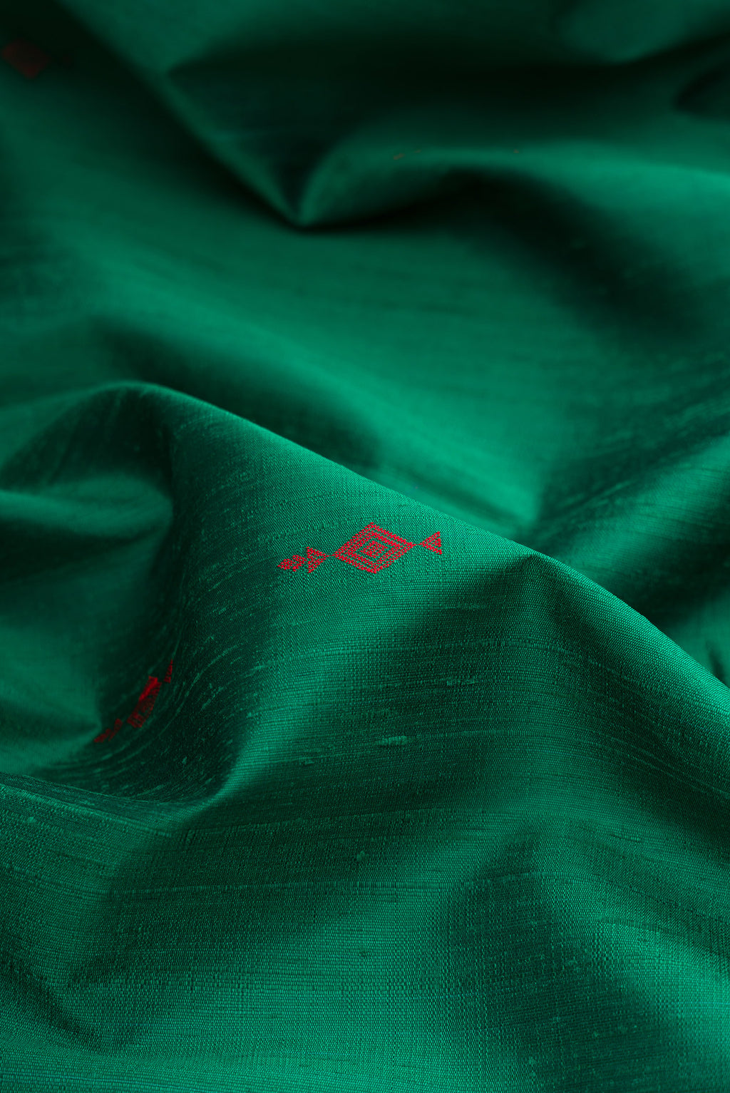 Close up of Green Raw Saree with Thread Butta on the body and Thin Zari Line.  displaying folds