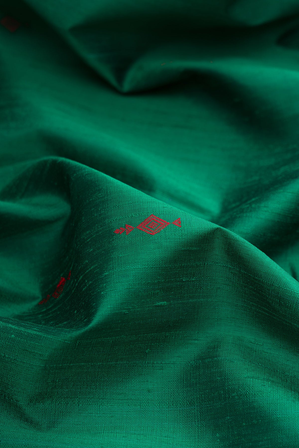 Close up of Green Raw Saree with Thread Butta on the body and Thin Zari Line.  displaying folds