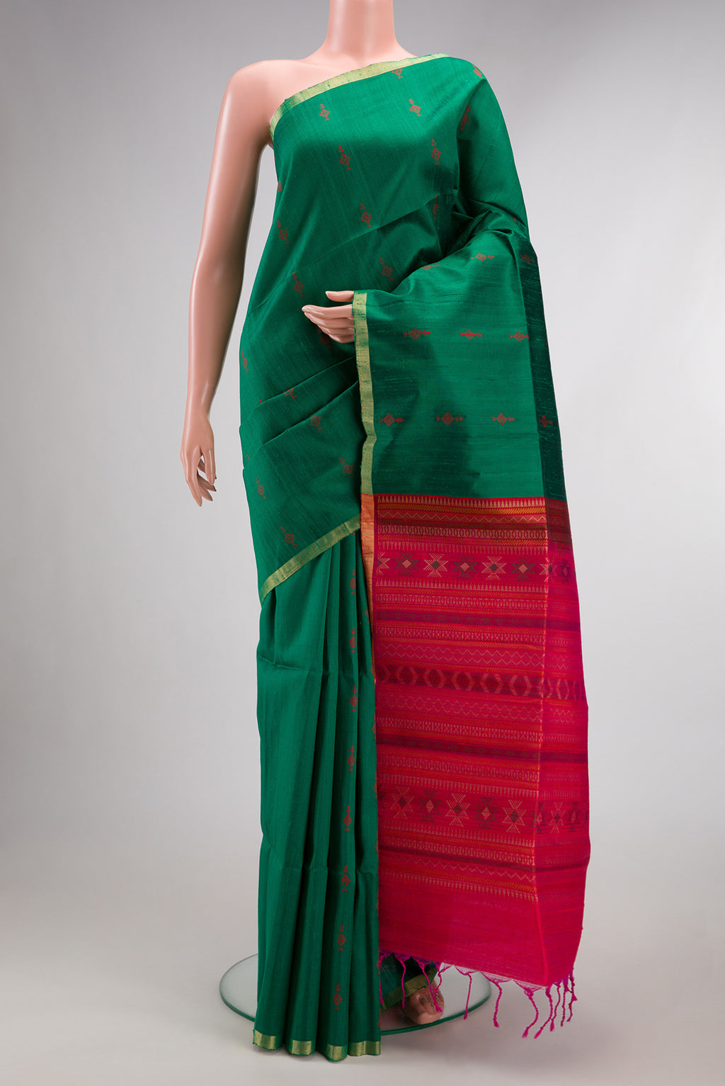 Green Raw Saree with Thread Butta on the body and Thin Zari Line.  displayed on a mannequin