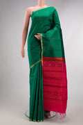 Green Raw Saree with Thread Butta on the body and Thin Zari Line.  displayed on a mannequin
