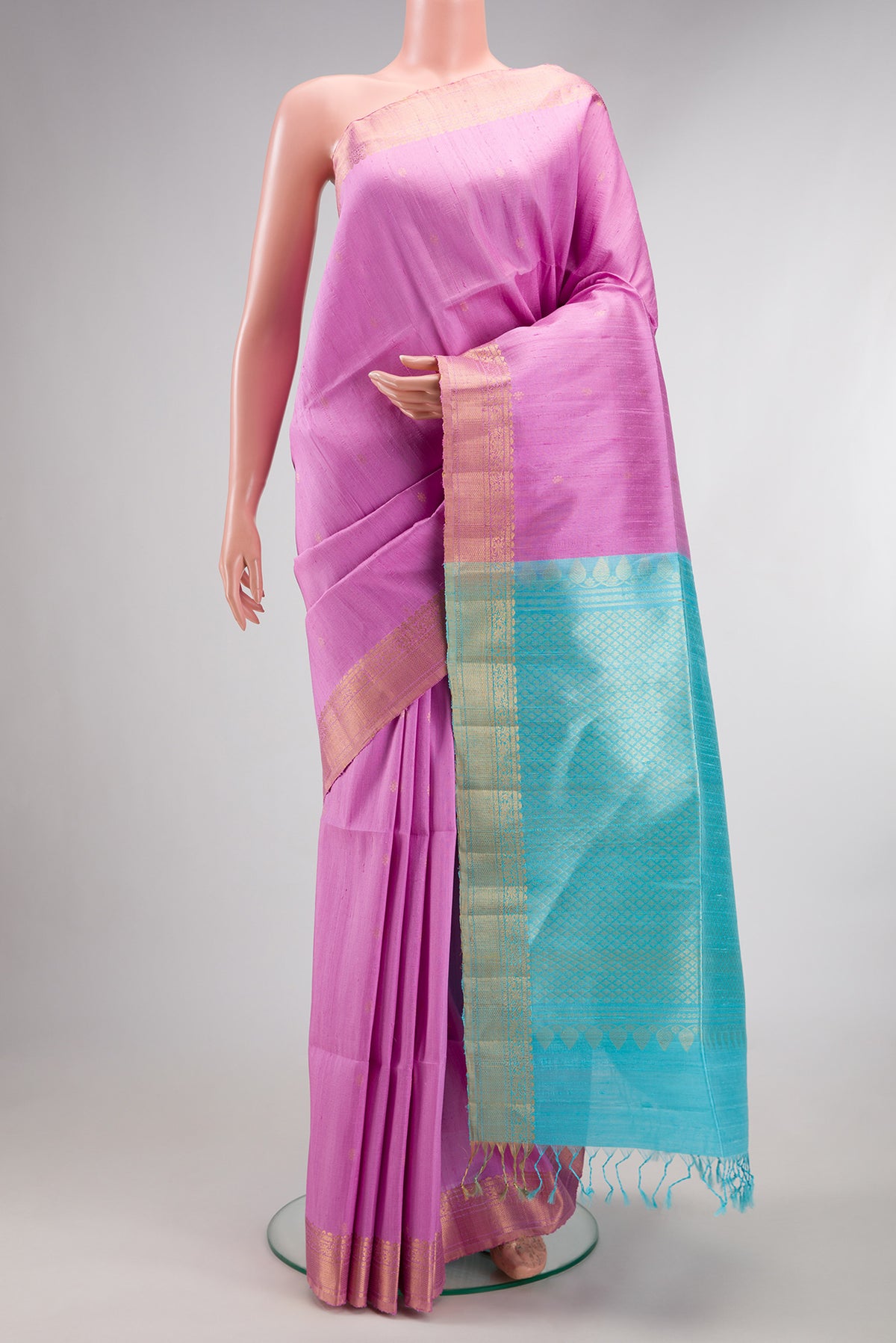 Lavender Dual Tone Raw Saree with Zari Butta on the body and Zari Border.  displayed on a mannequin