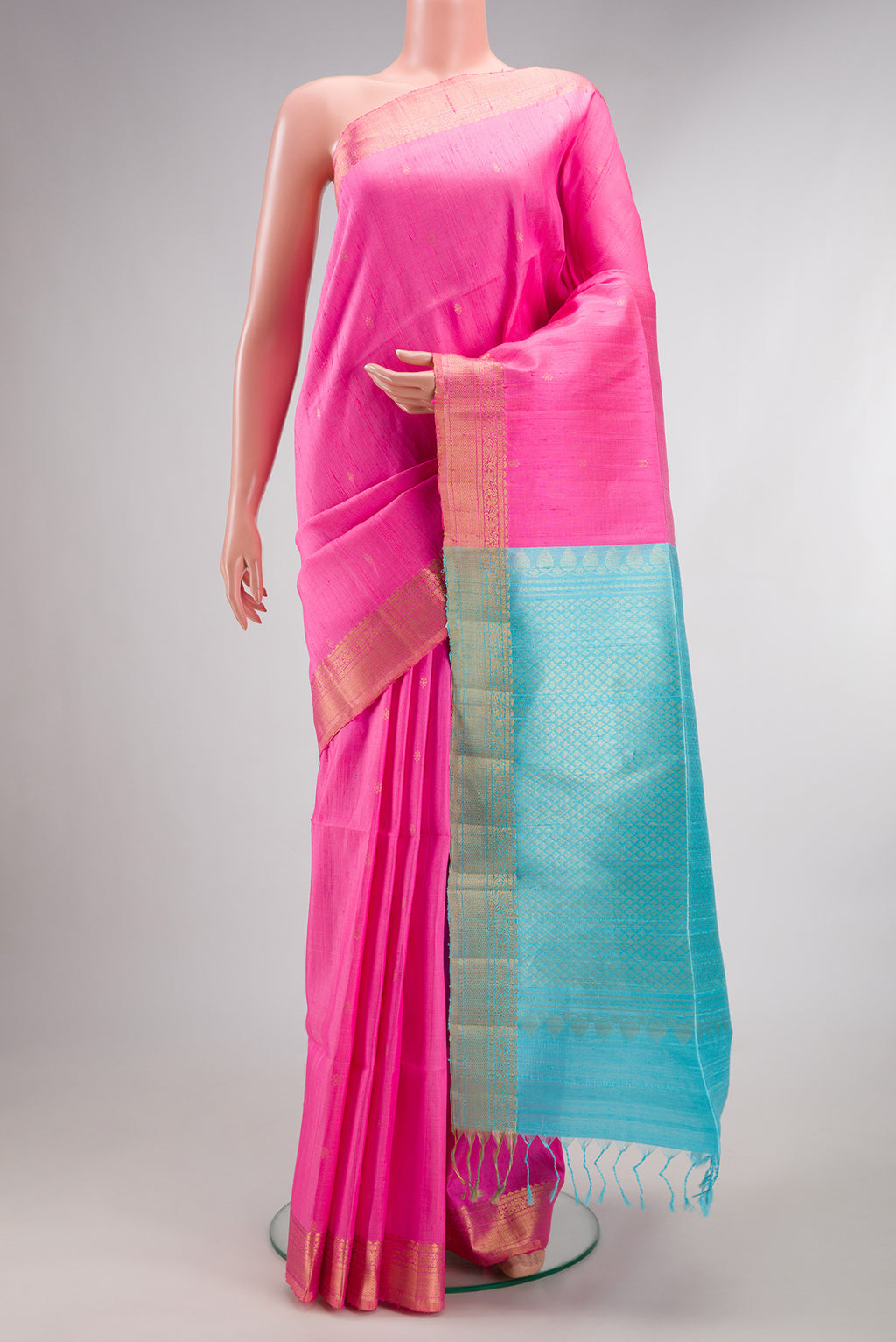 Pink Raw Saree with Zari Butta on the body and Zari Border.  displayed on a mannequin
