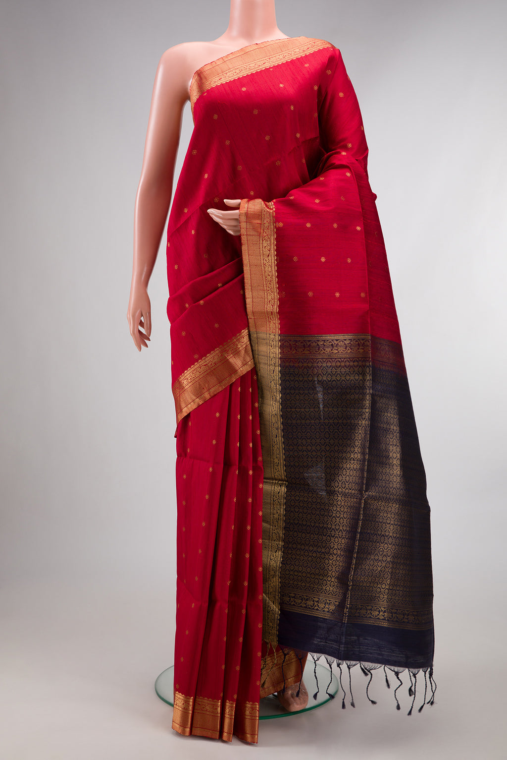 Deep Red Raw Saree with Zari Butta on the body and Zari Border.  displayed on a mannequin