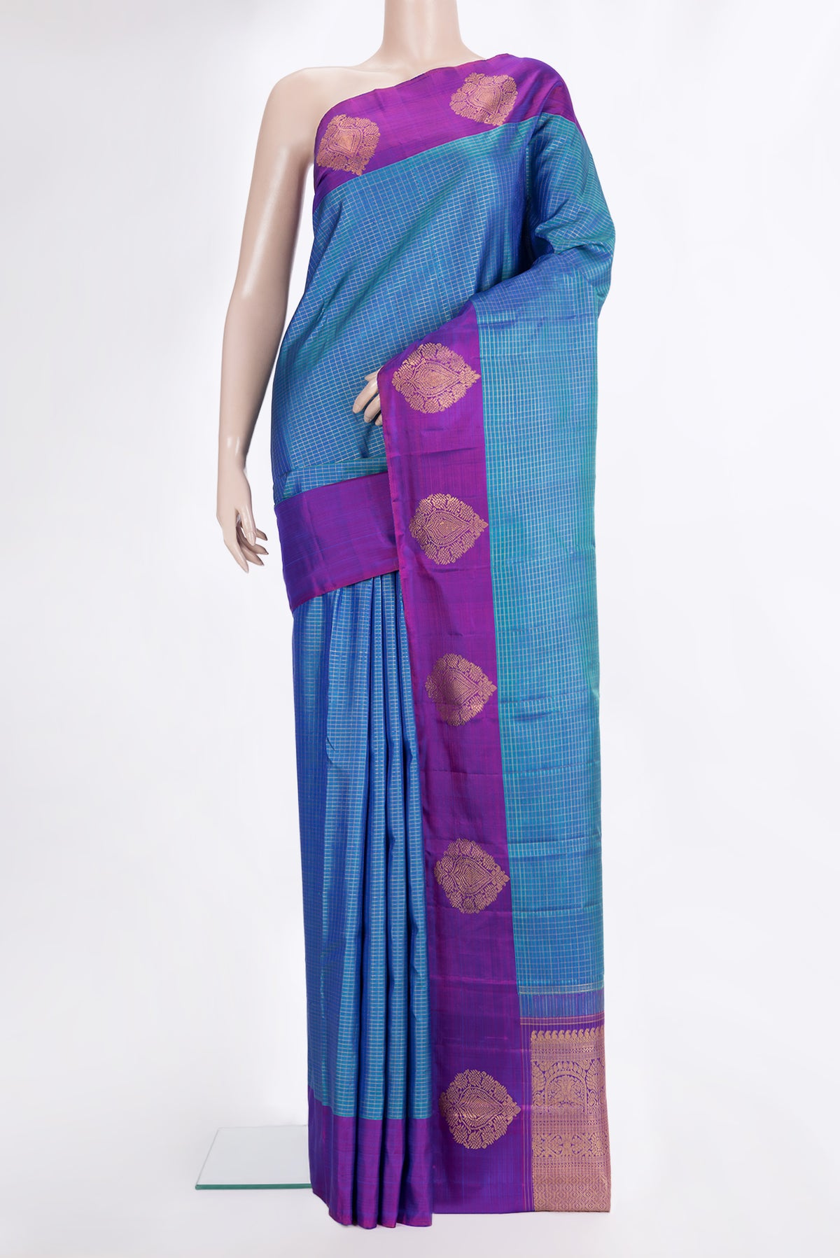 Pure Silk Peacock Blue Kanjivaram Saree with Checked design on the body and Fancy Border.  displayed on a mannequin