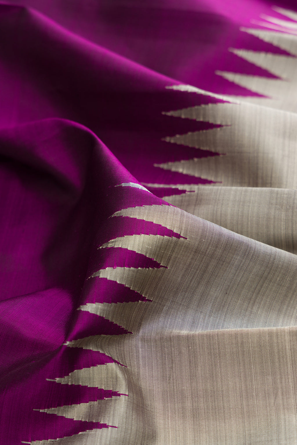 Close up of Pure Silk Grey and Purple Color Kanchipuram Saree with Half And Half on the body and Rising Temple Border.  displaying folds