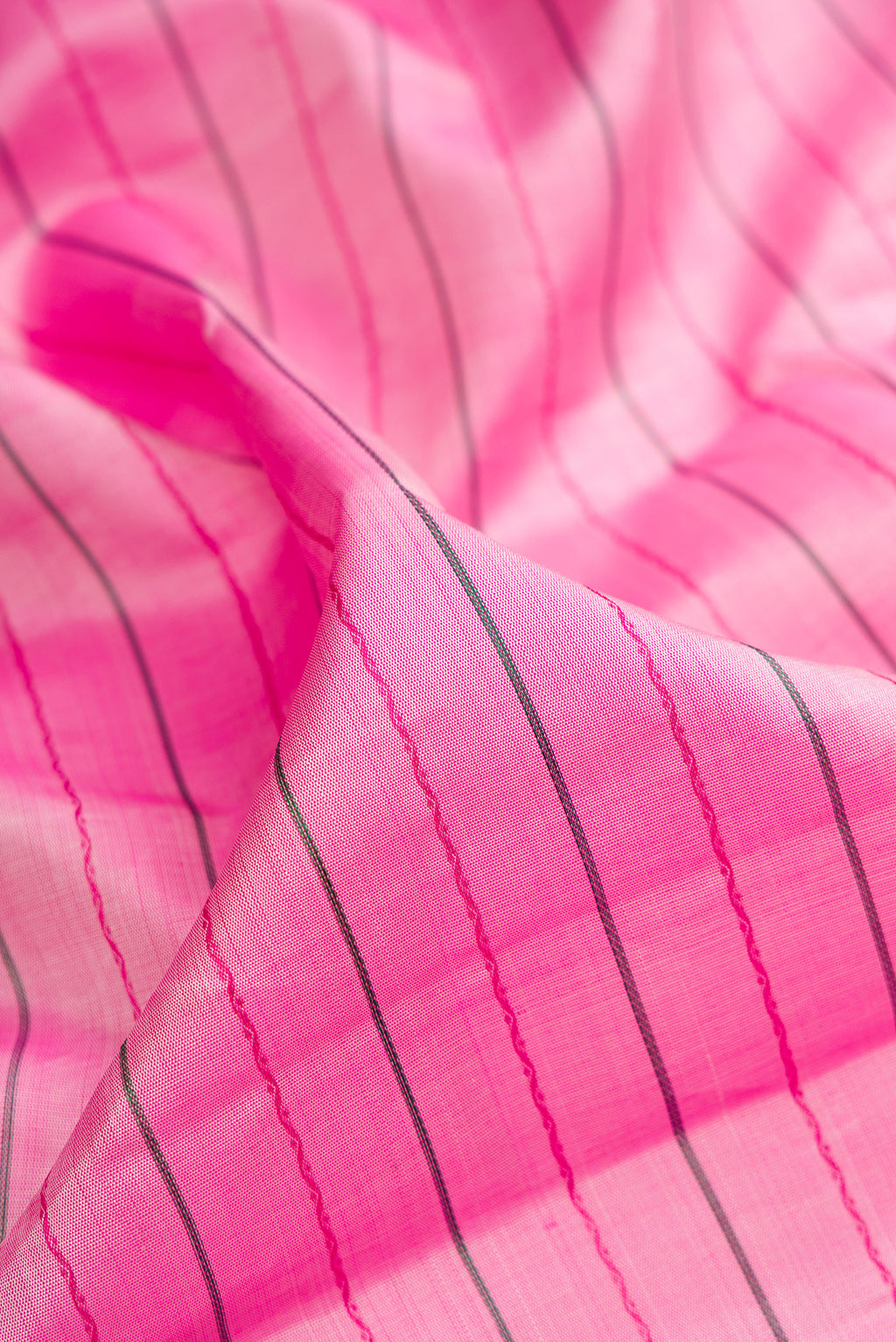 Close up of Pure Silk Pink Kanjivaram Saree with Veldhari on the body and Ganga Jamuna Border.  displaying folds