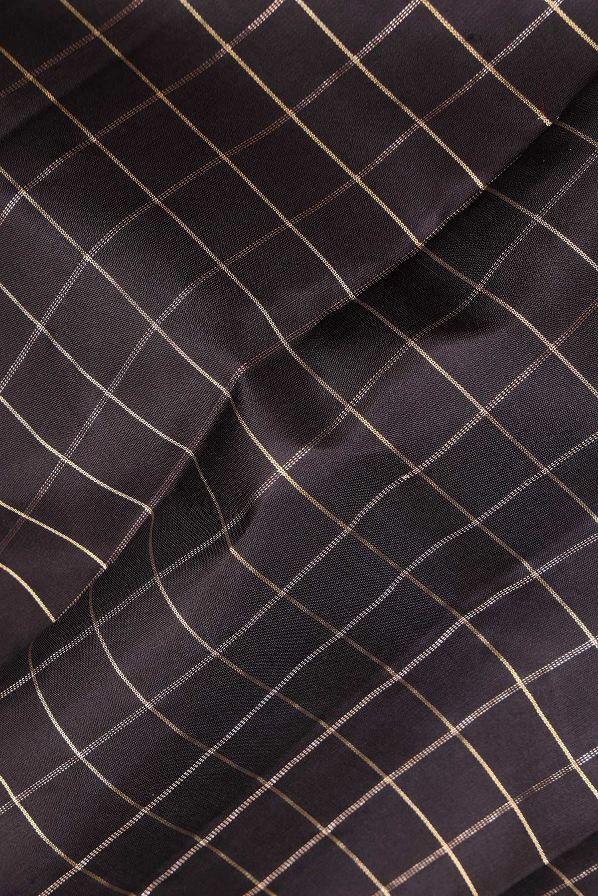 Close up of Pure Silk Black Kanjivaram Saree with Checked design on the body and Zari Border.  displaying folds