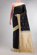 Pure Silk Black Kanjivaram Saree with Zari Butta on the body and Zari Border.  displayed on a mannequin