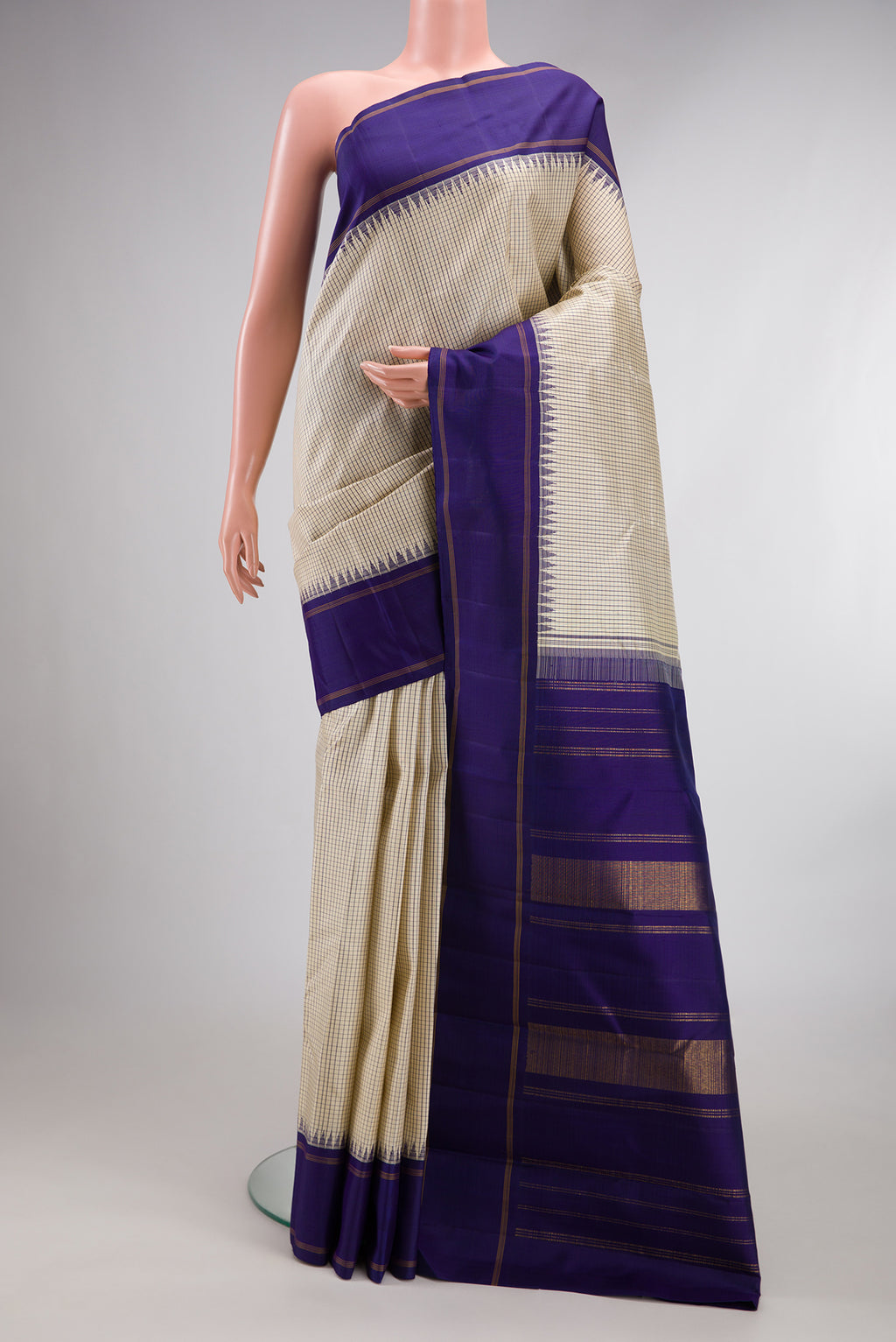 Pure Silk Pure Zari Beige Kanjivaram Saree with Checked design on the body and Temple Border.  displayed on a mannequin