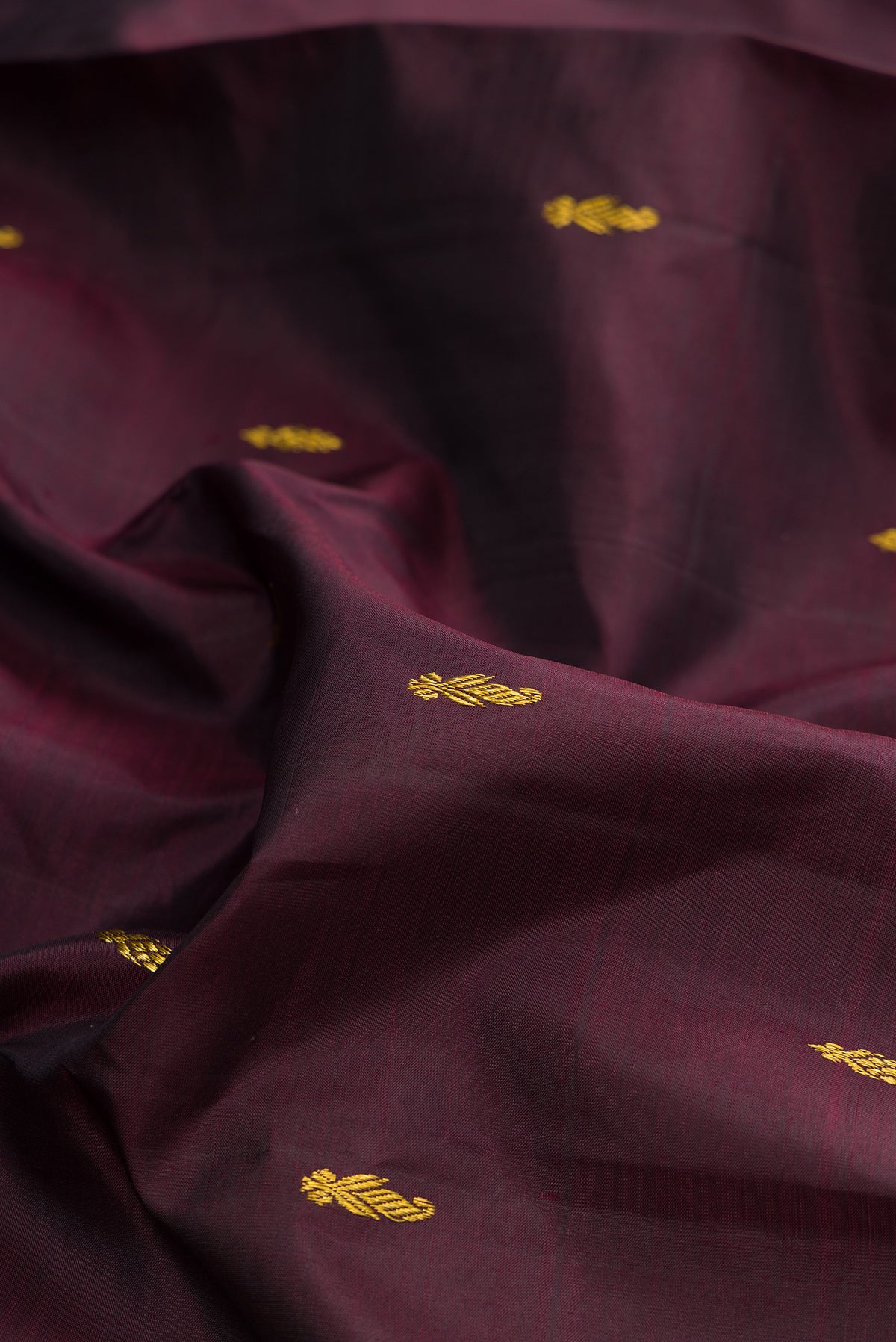 Close up of Pure Silk Pure Zari Coffee Brown Kanjivaram Saree with Zari Butta on the body and One Side Border.  displaying folds
