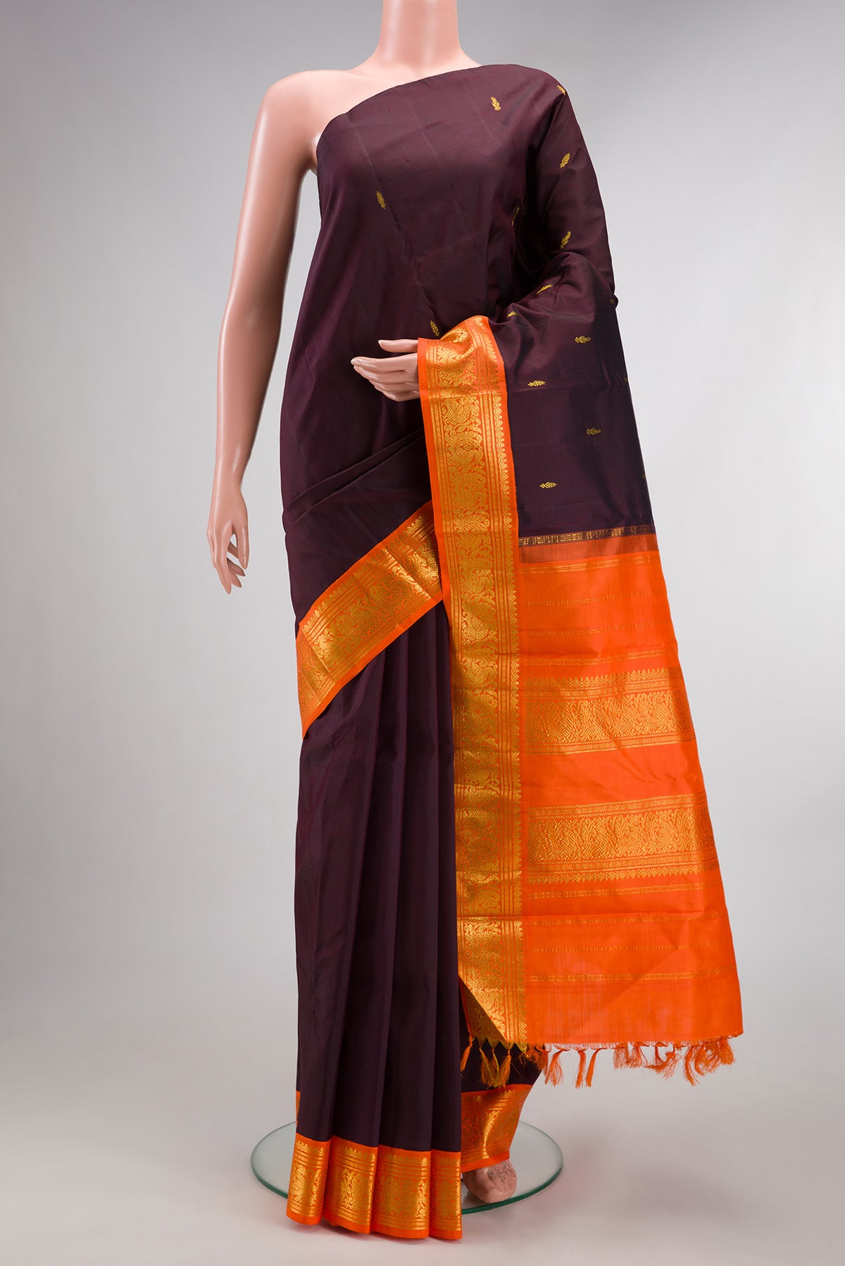Pure Silk Pure Zari Coffee Brown Kanjivaram Saree with Zari Butta on the body and One Side Border.  displayed on a mannequin