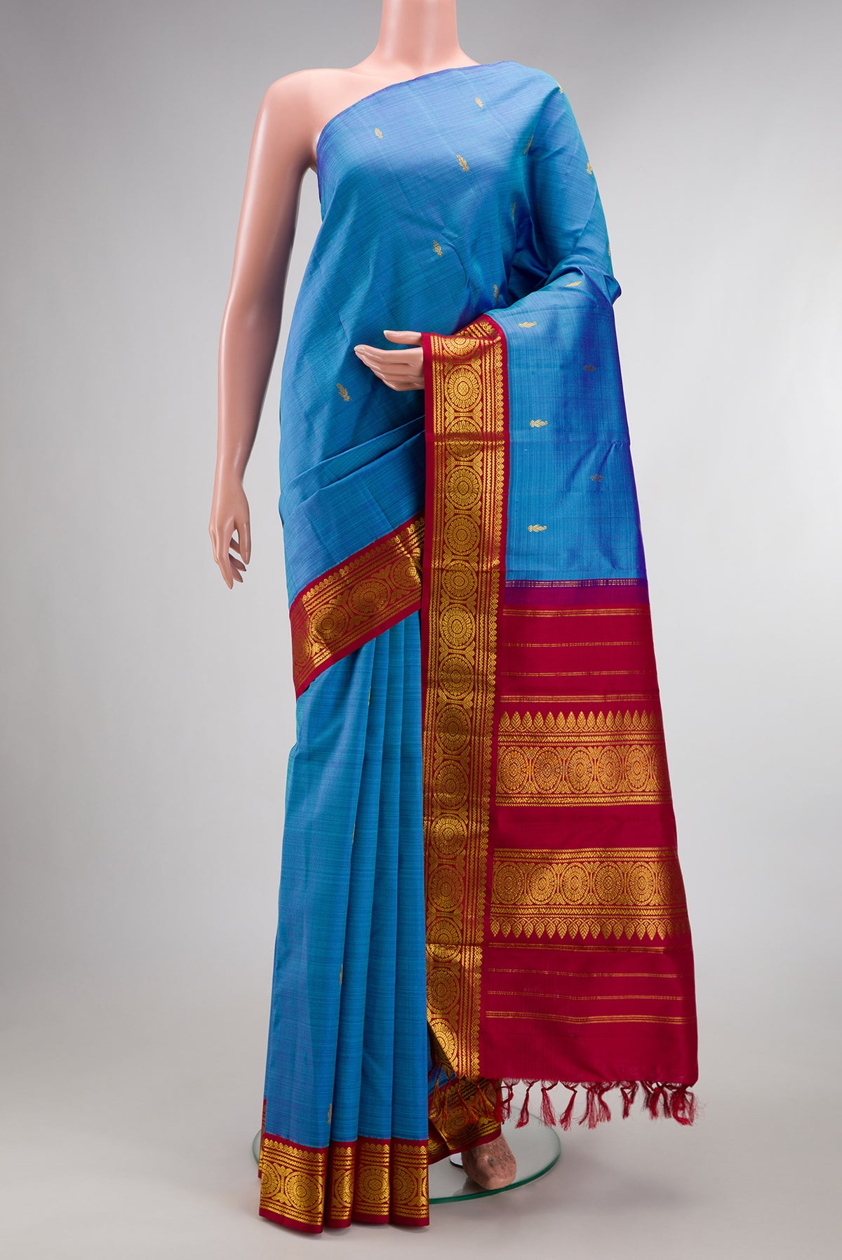 Pure Silk Pure Zari Sky Blue Kanjivaram Saree with Zari Butta on the body and One Side Border.  displayed on a mannequin