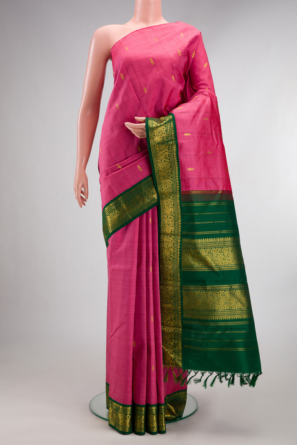 Pure Silk Pure Zari Pink Kanjivaram Saree with Zari Butta on the body and One Side Border.  displayed on a mannequin