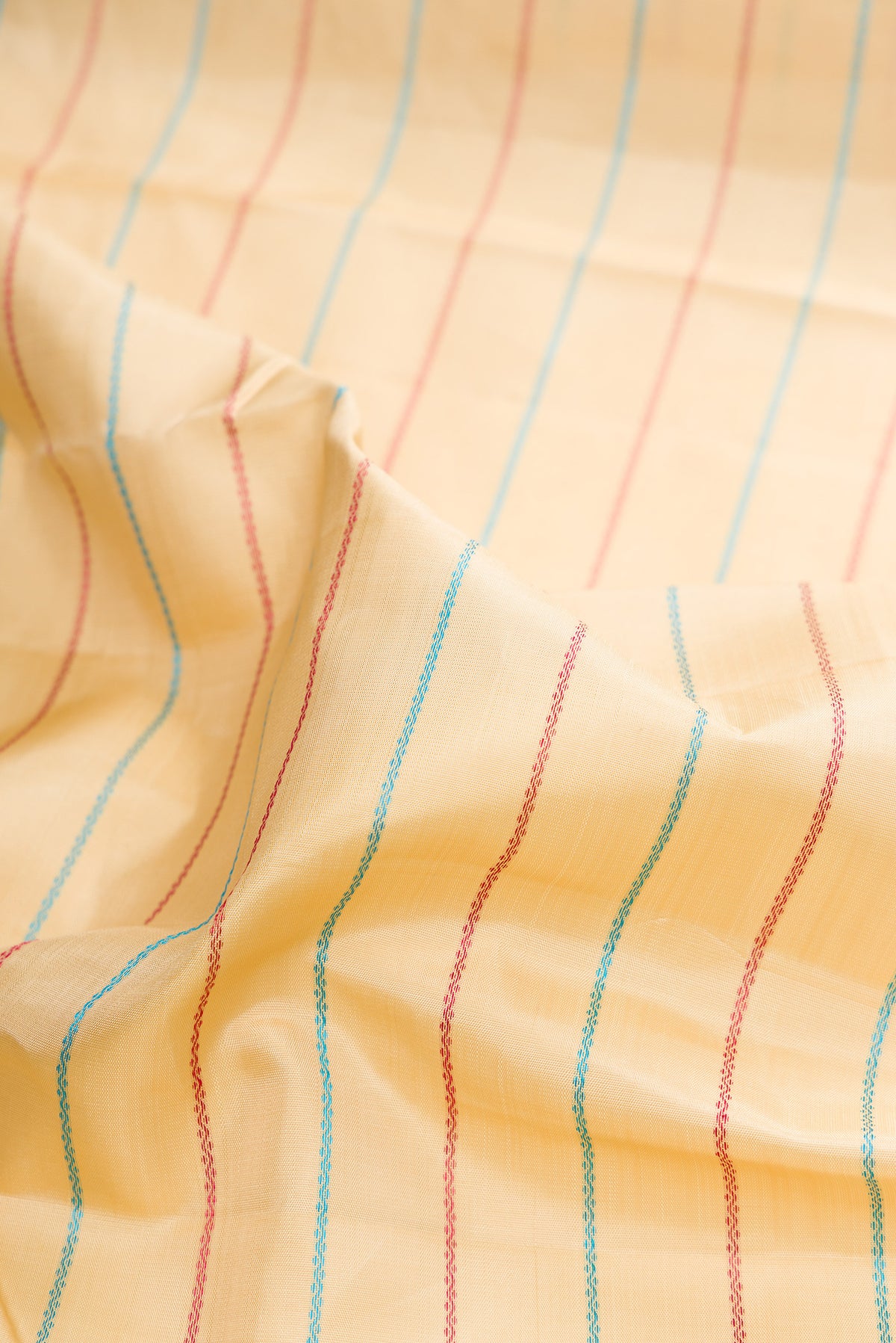 Close up of Pure Silk Sandal Kanchipuram Saree with Veldhari on the body and Thread Border.  displaying folds