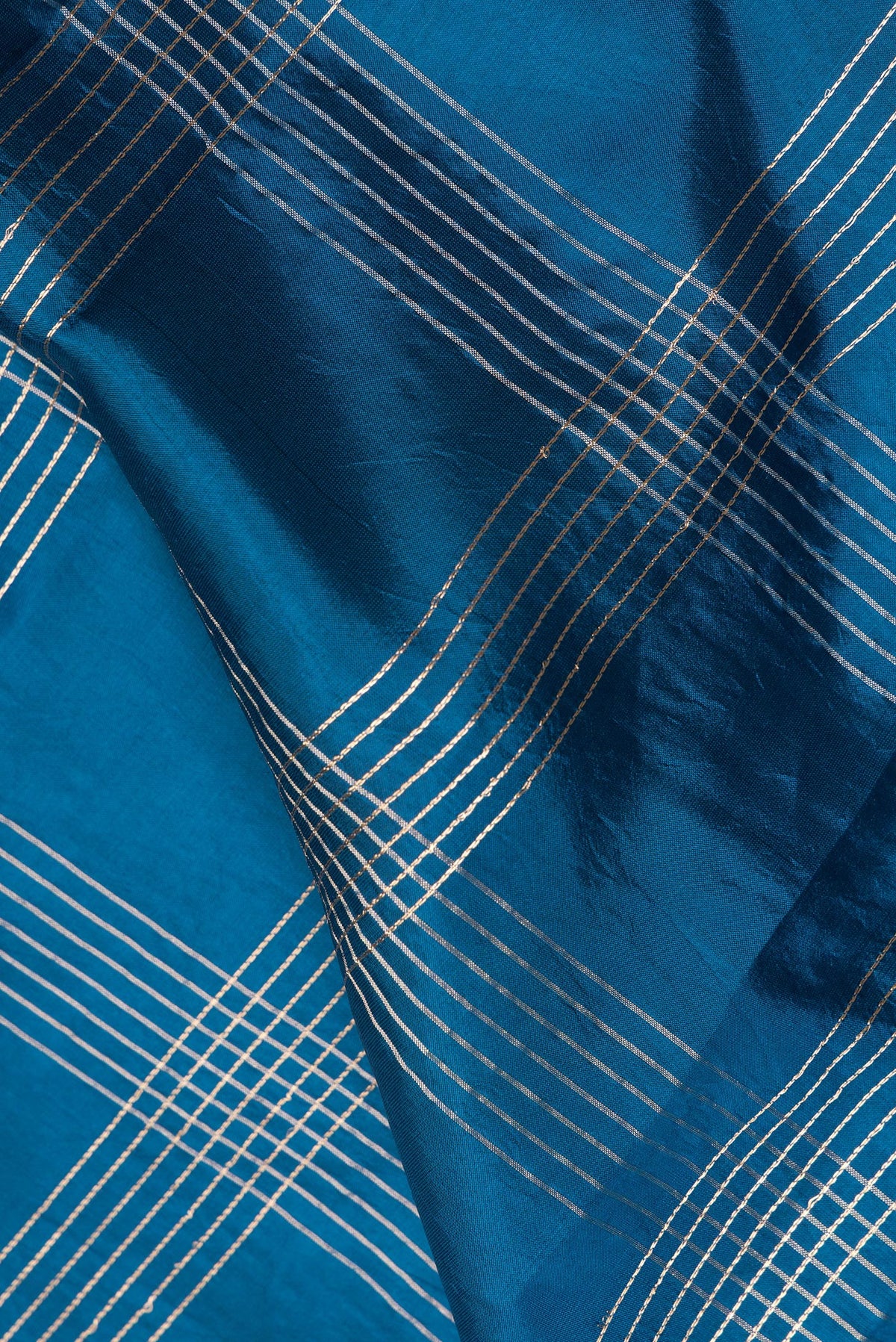 Close up of Pure Silk Peacock Blue Banarasi Saree with Checked design on the body and Fancy Border.  displaying folds
