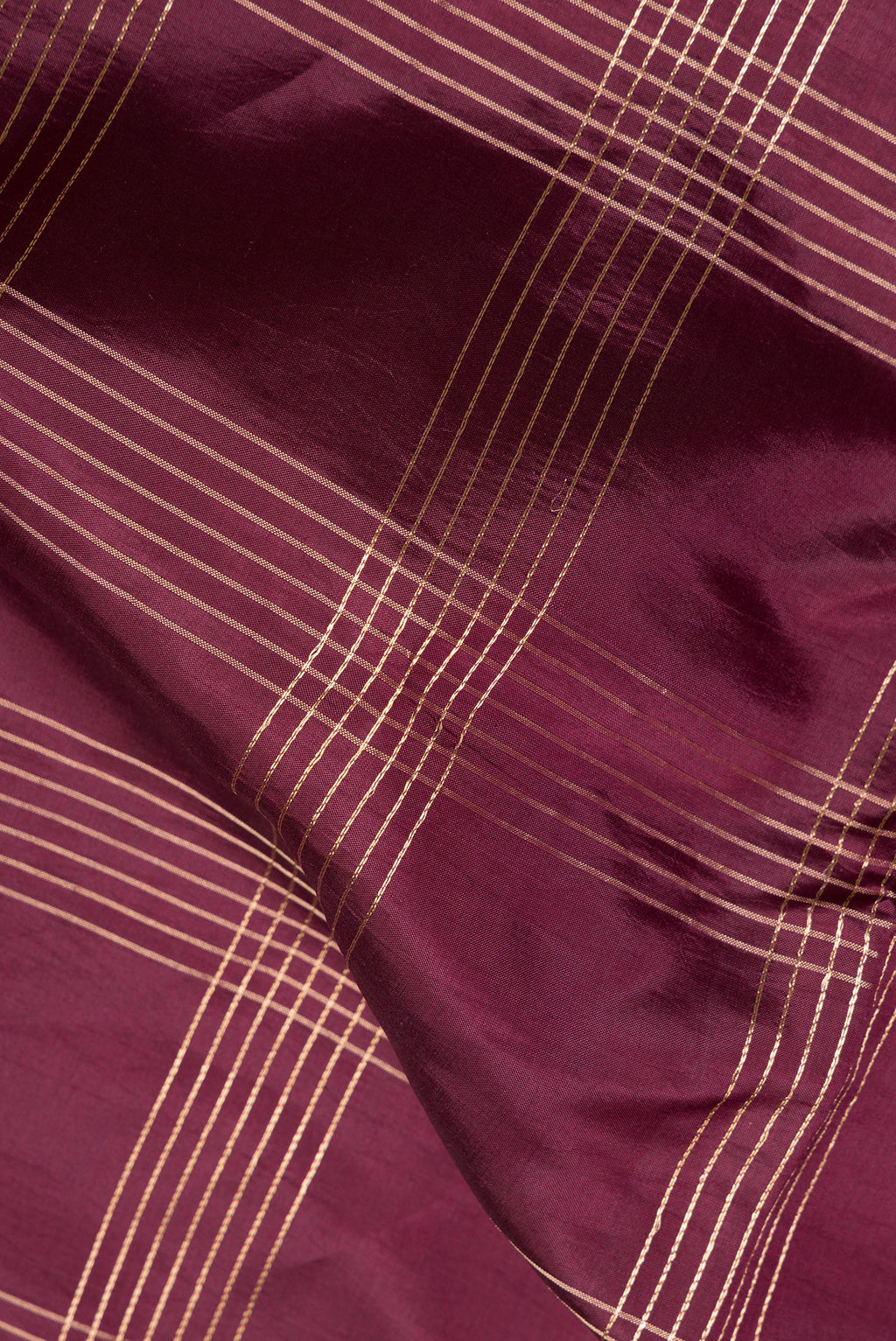 Close up of Maroon Tussar Saree with Checked design on the body and Fancy Border.  displaying folds