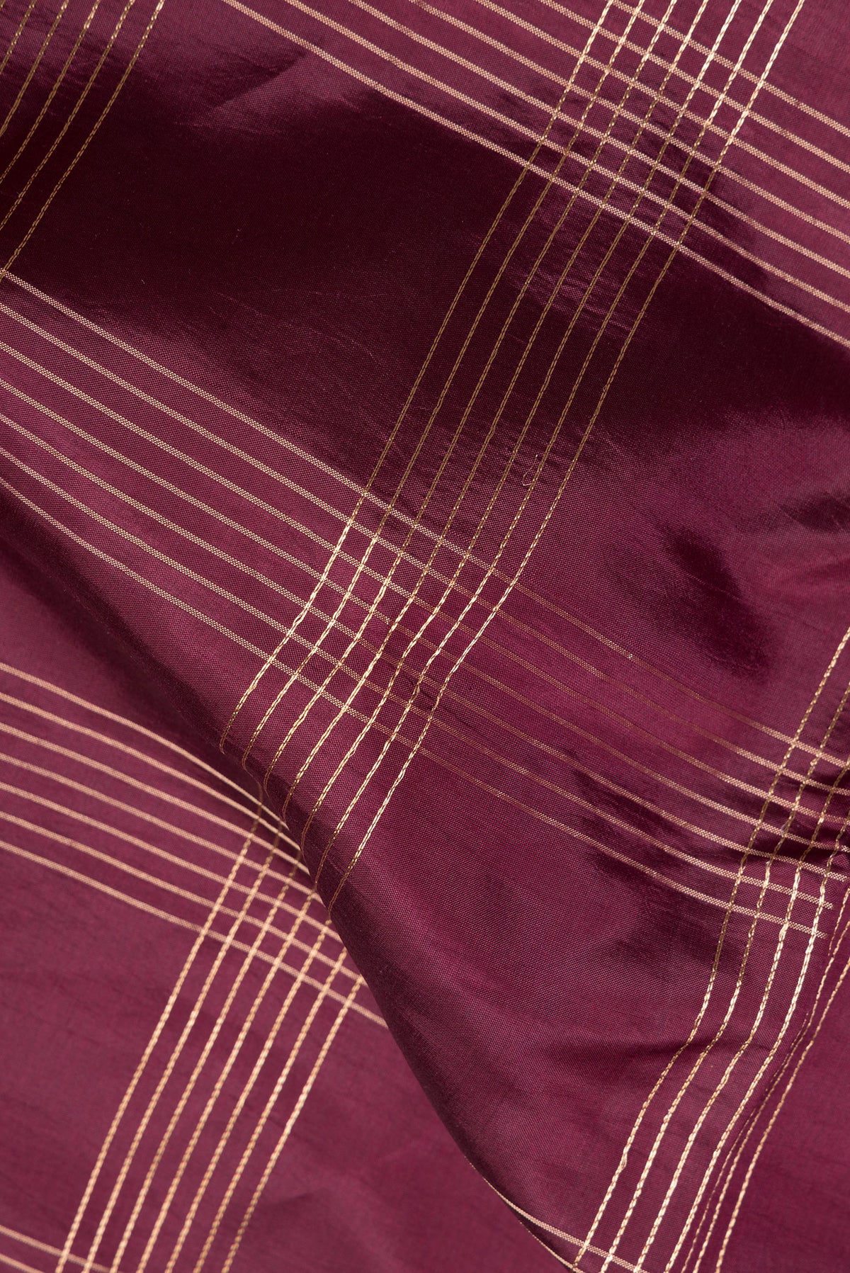 Close up of Maroon Tussar Saree with Checked design on the body and Fancy Border.  displaying folds