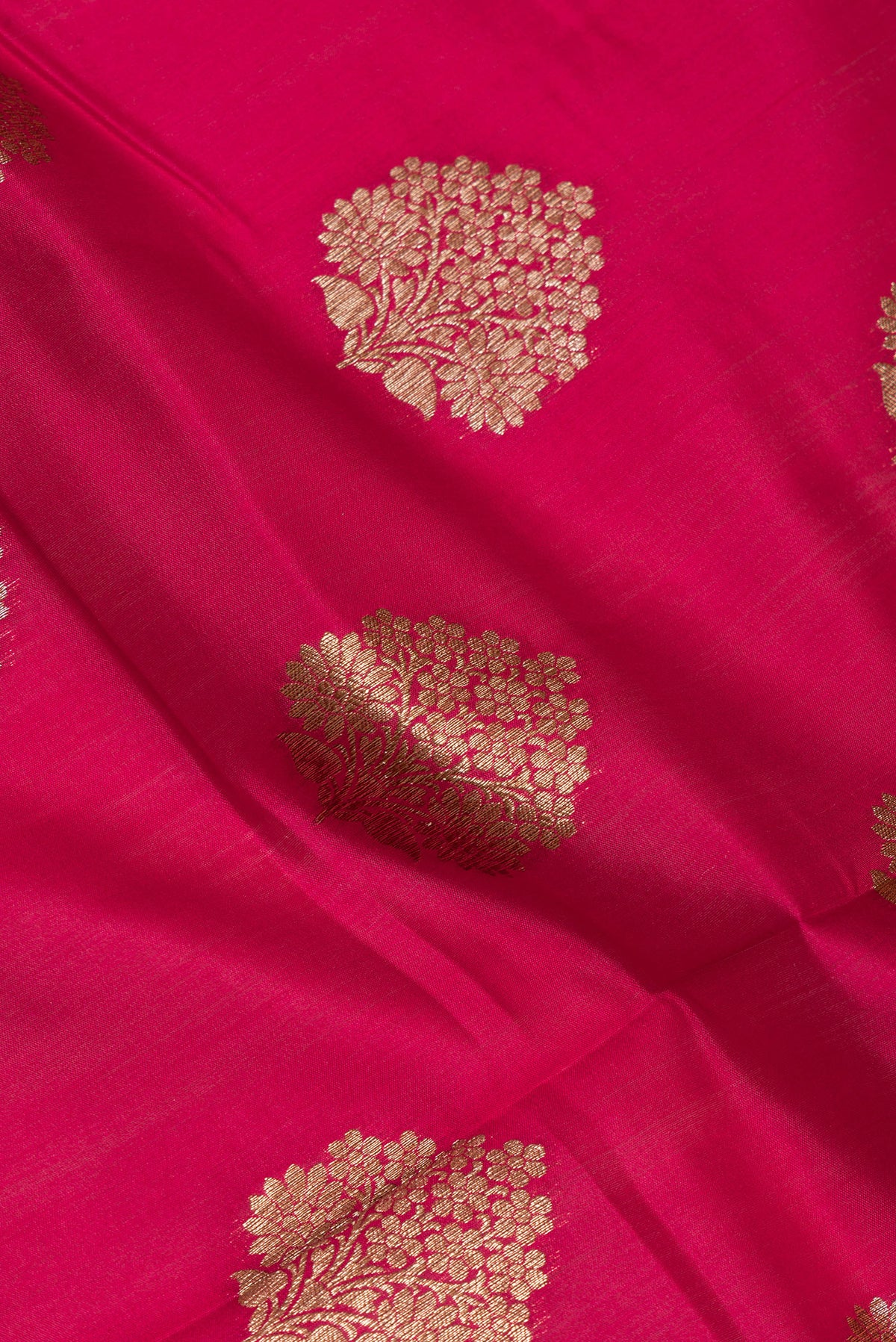Close up of Red Raw Saree with Zari Butta on the body and Zari Border.  displaying folds