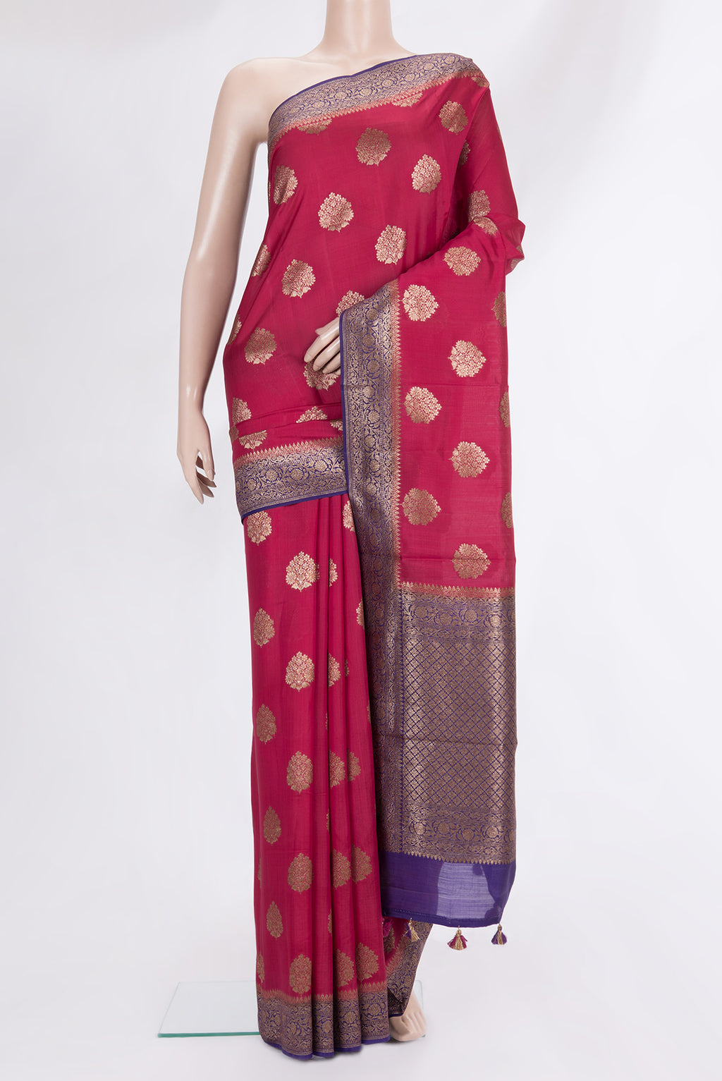 Red Raw Saree with Zari Butta on the body and Zari Border.  displayed on a mannequin