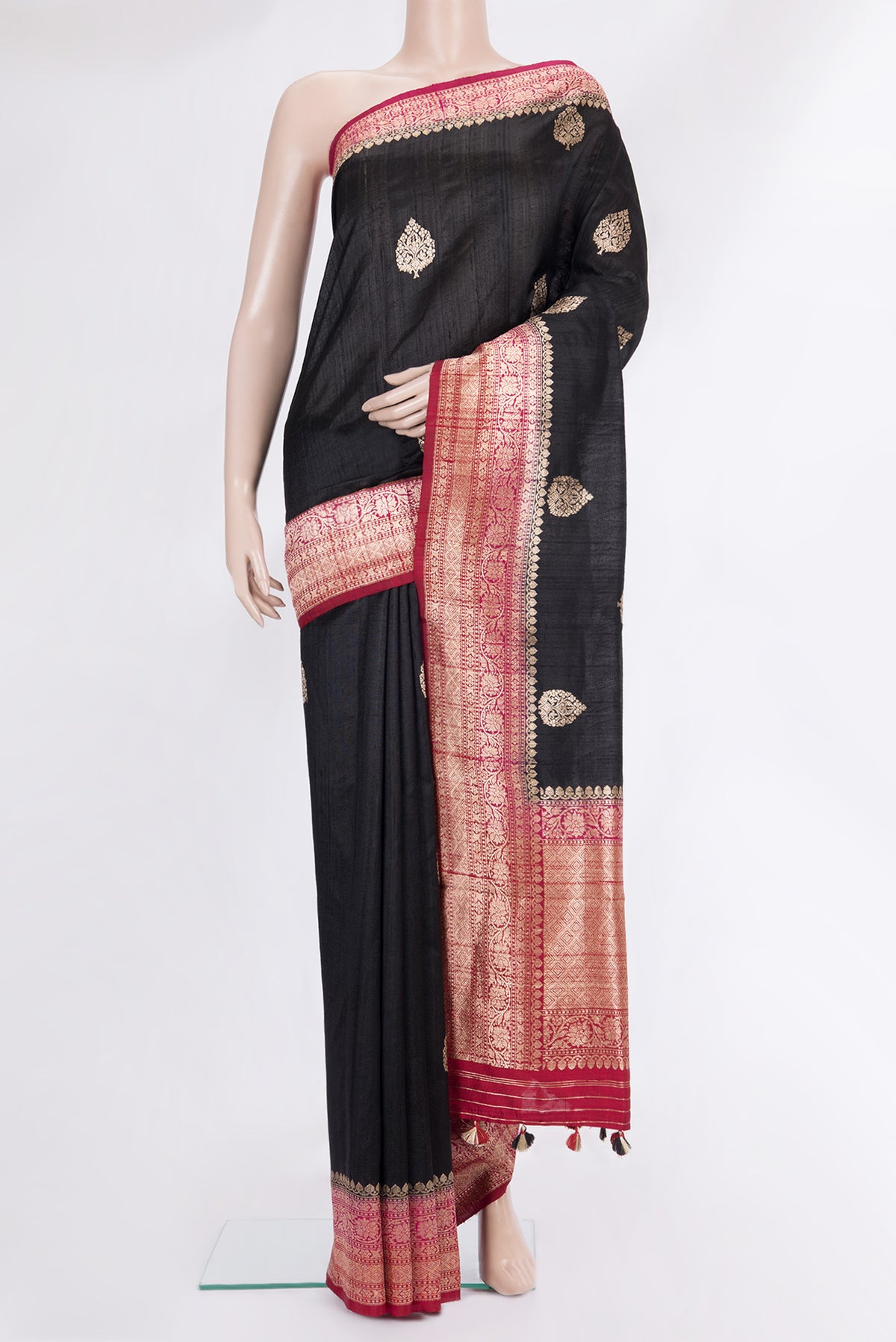 Pure Silk Black Banarasi Tussar Saree with Zari Butta on the body and Zari Border.  displayed on a mannequin