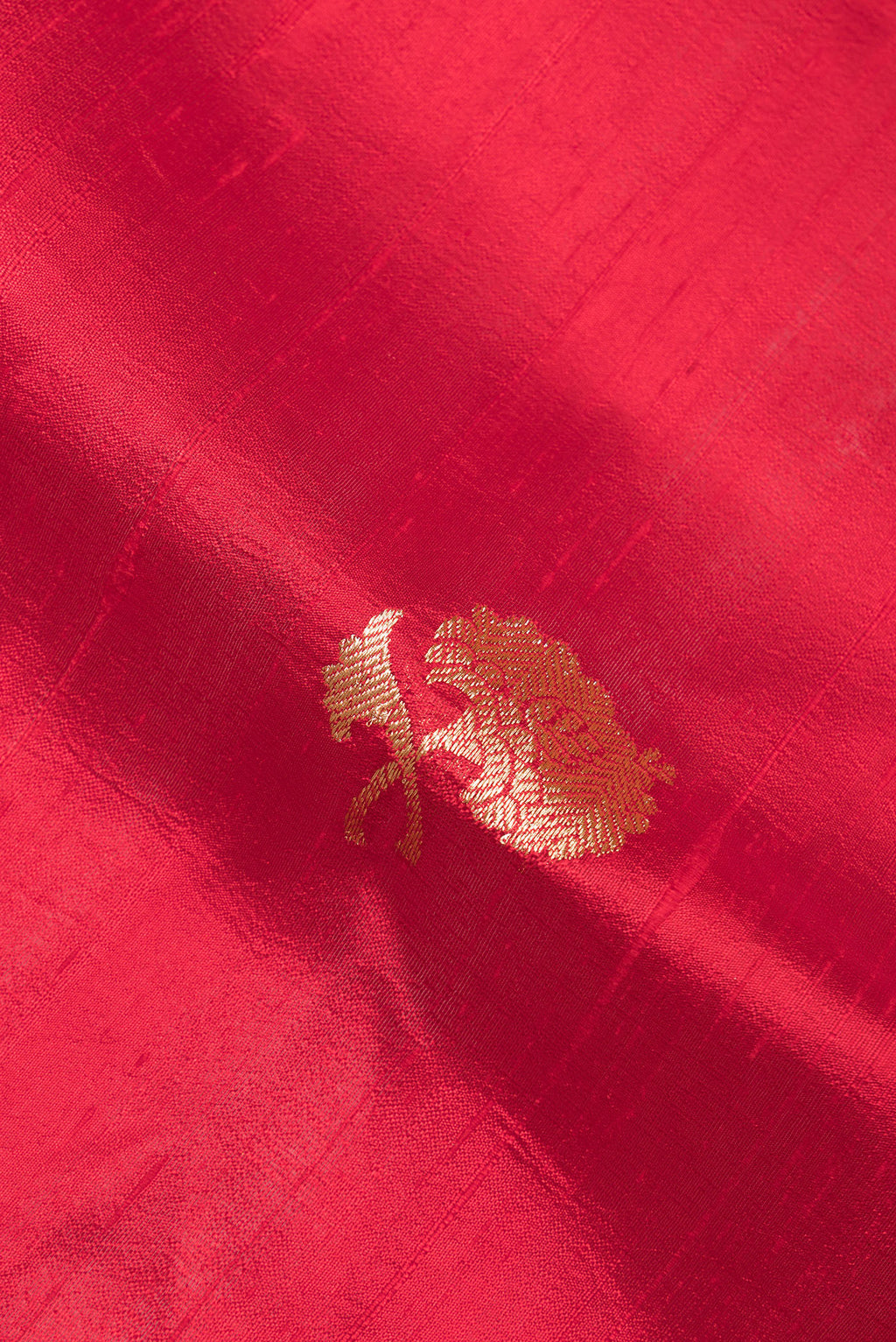 Close up of Pure Silk Red Banarasi Tussar Saree with Zari Butta on the body and Zari Border.  displaying folds