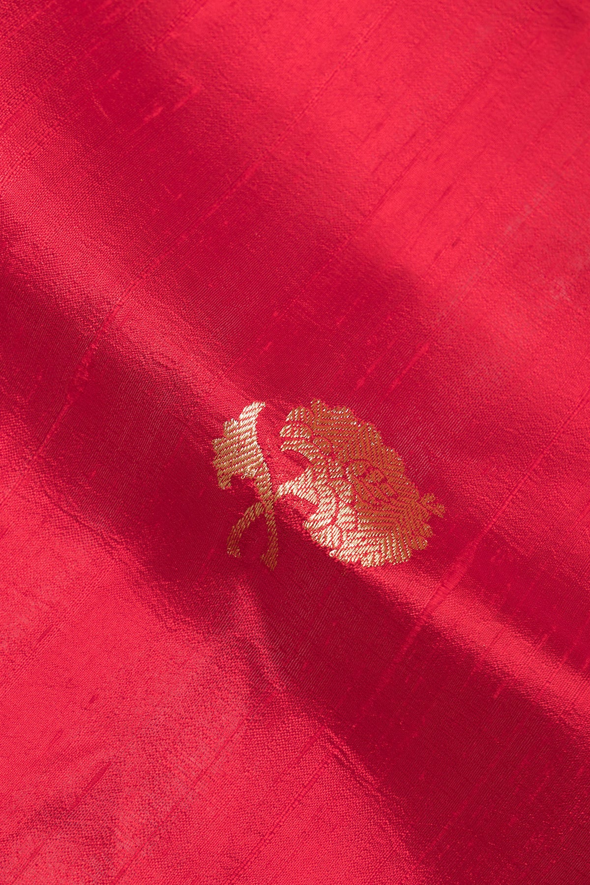 Close up of Pure Silk Red Banarasi Tussar Saree with Zari Butta on the body and Zari Border.  displaying folds
