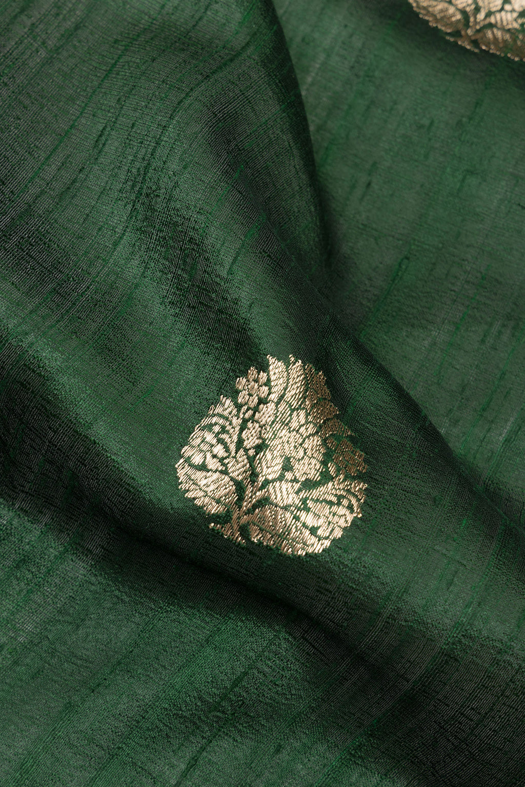 Close up of Pure Silk Bottle Green Banarasi Tussar Saree with Zari Butta on the body and Zari Border.  displaying folds