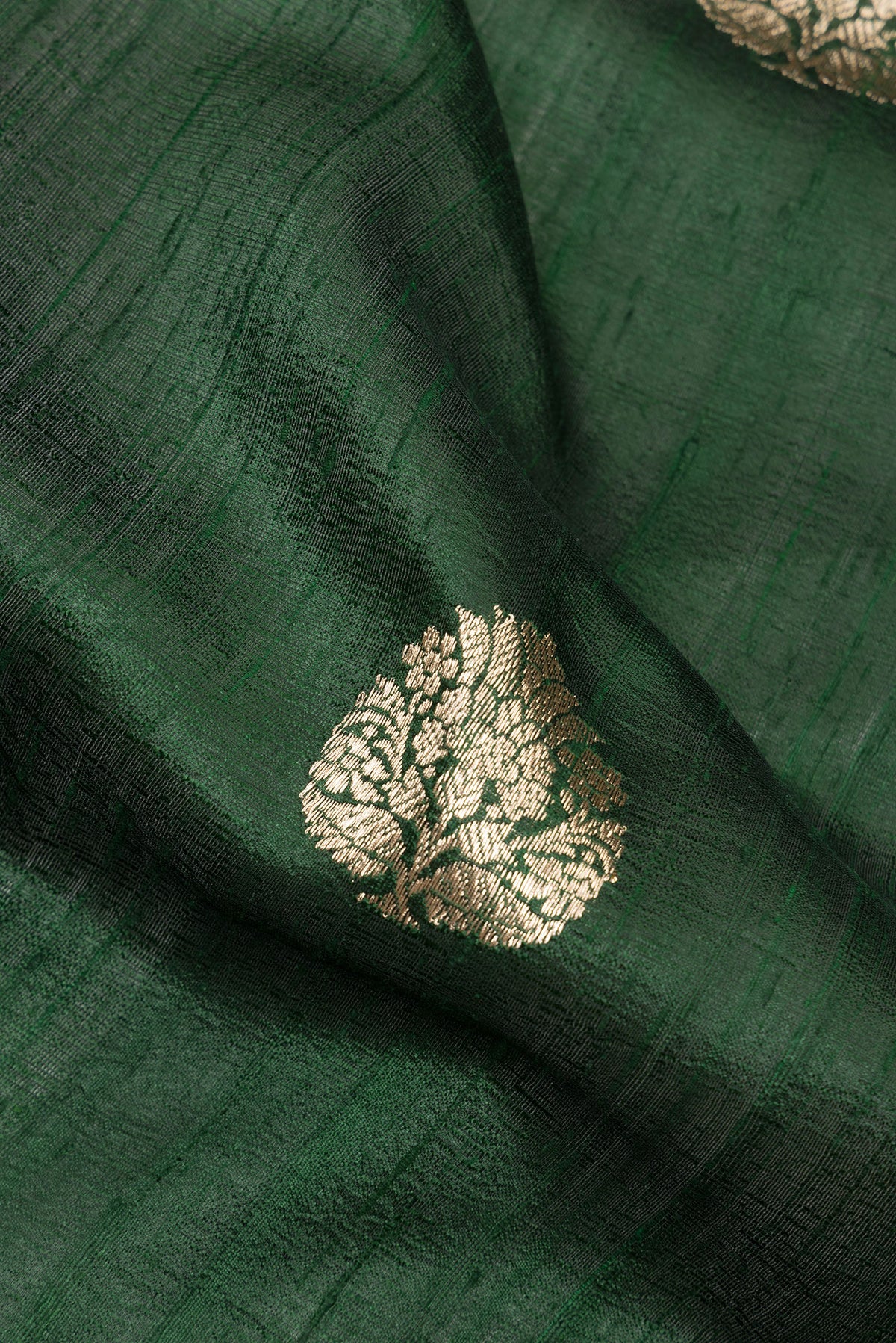 Close up of Pure Silk Bottle Green Banarasi Tussar Saree with Zari Butta on the body and Zari Border.  displaying folds