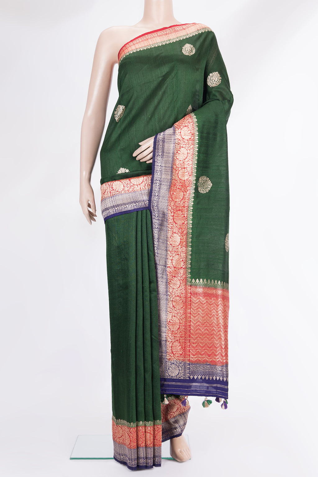Pure Silk Bottle Green Banarasi Tussar Saree with Zari Butta on the body and Zari Border.  displayed on a mannequin