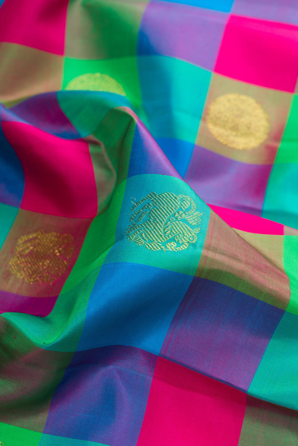 Close up of Pure Silk Multi Color Kanjivaram Saree with Checked design on the body and Zari Border.  displaying folds
