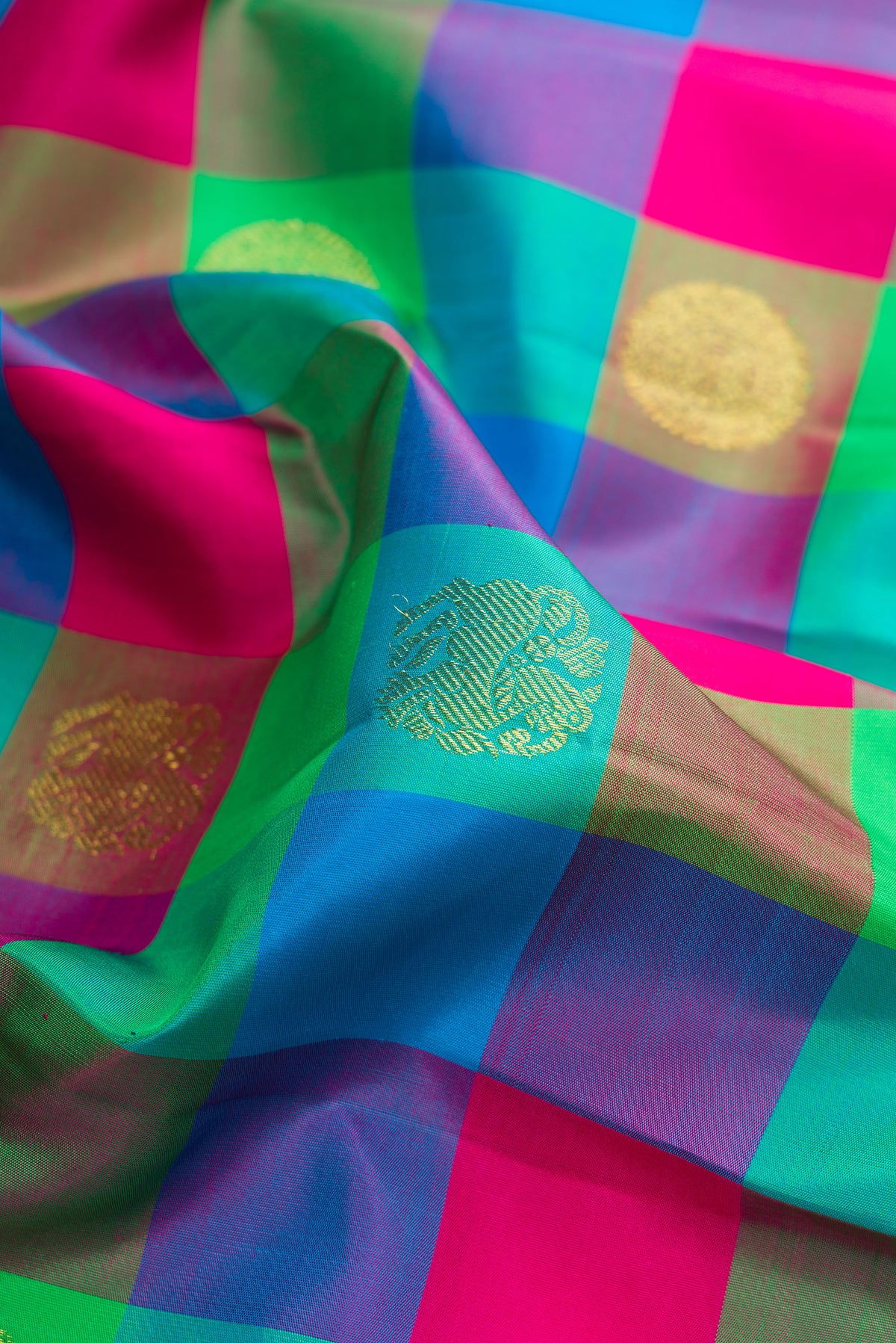 Close up of Pure Silk Multi Color Kanjivaram Saree with Checked design on the body and Zari Border.  displaying folds