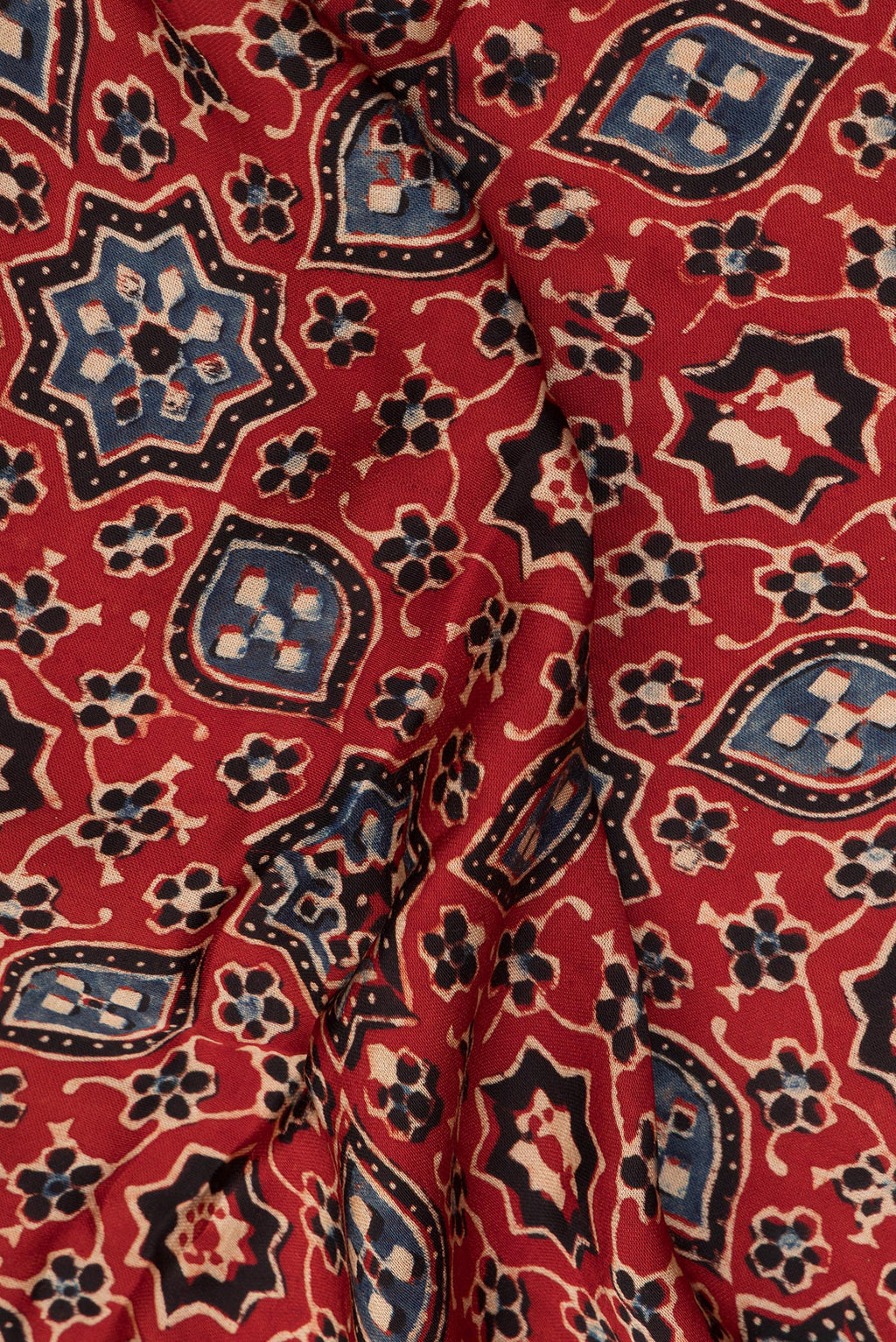 Close up of Rust Blended Satin Silk Saree with Ajrakh Print on the body and Printed Border.  displaying folds