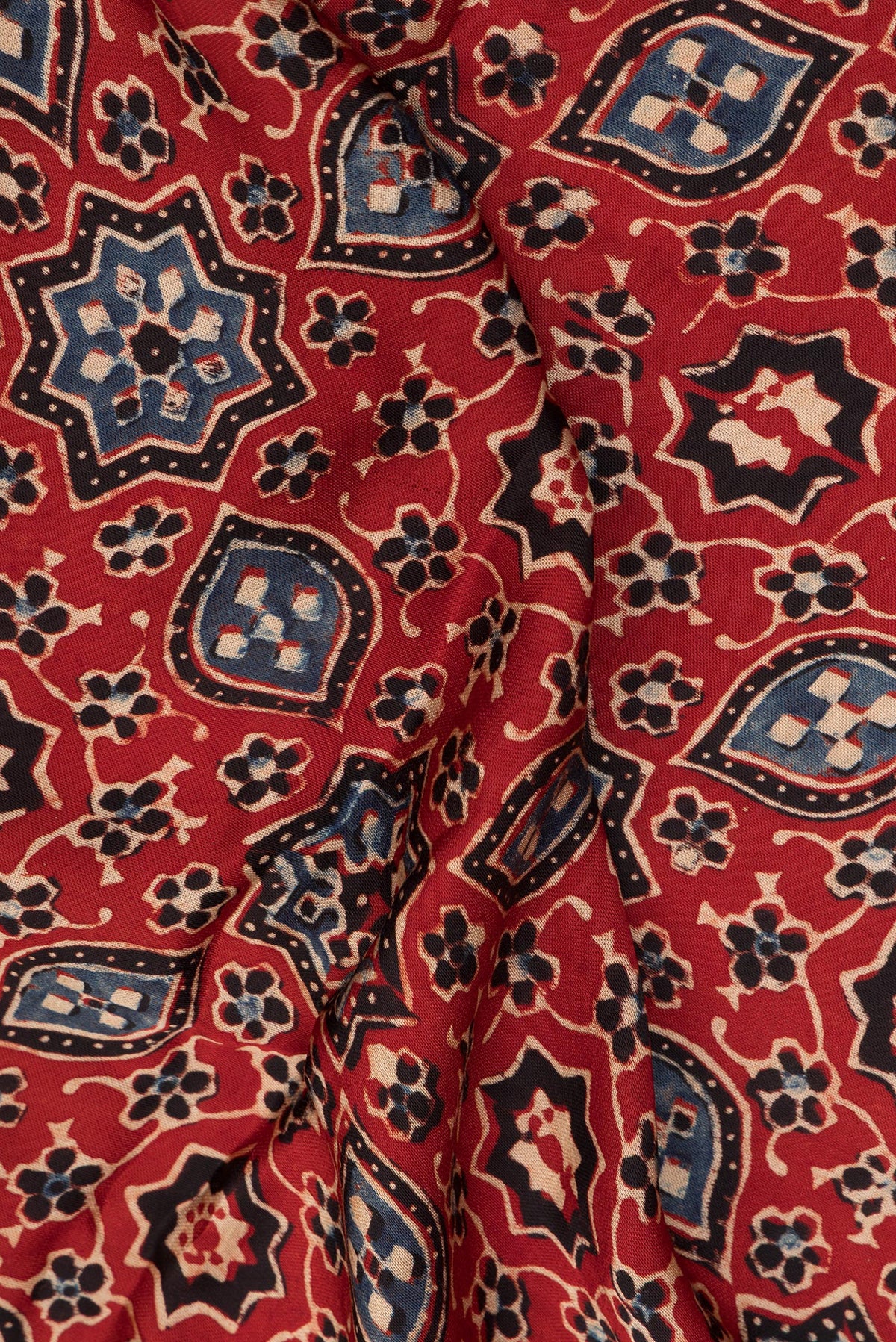Close up of Rust Blended Satin Silk Saree with Ajrakh Print on the body and Printed Border.  displaying folds