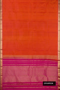 Brick Orange Dual Tone Kanchipuram Silk Saree with Zari Butta on the body and Zari Border.  displayed on a mannequin