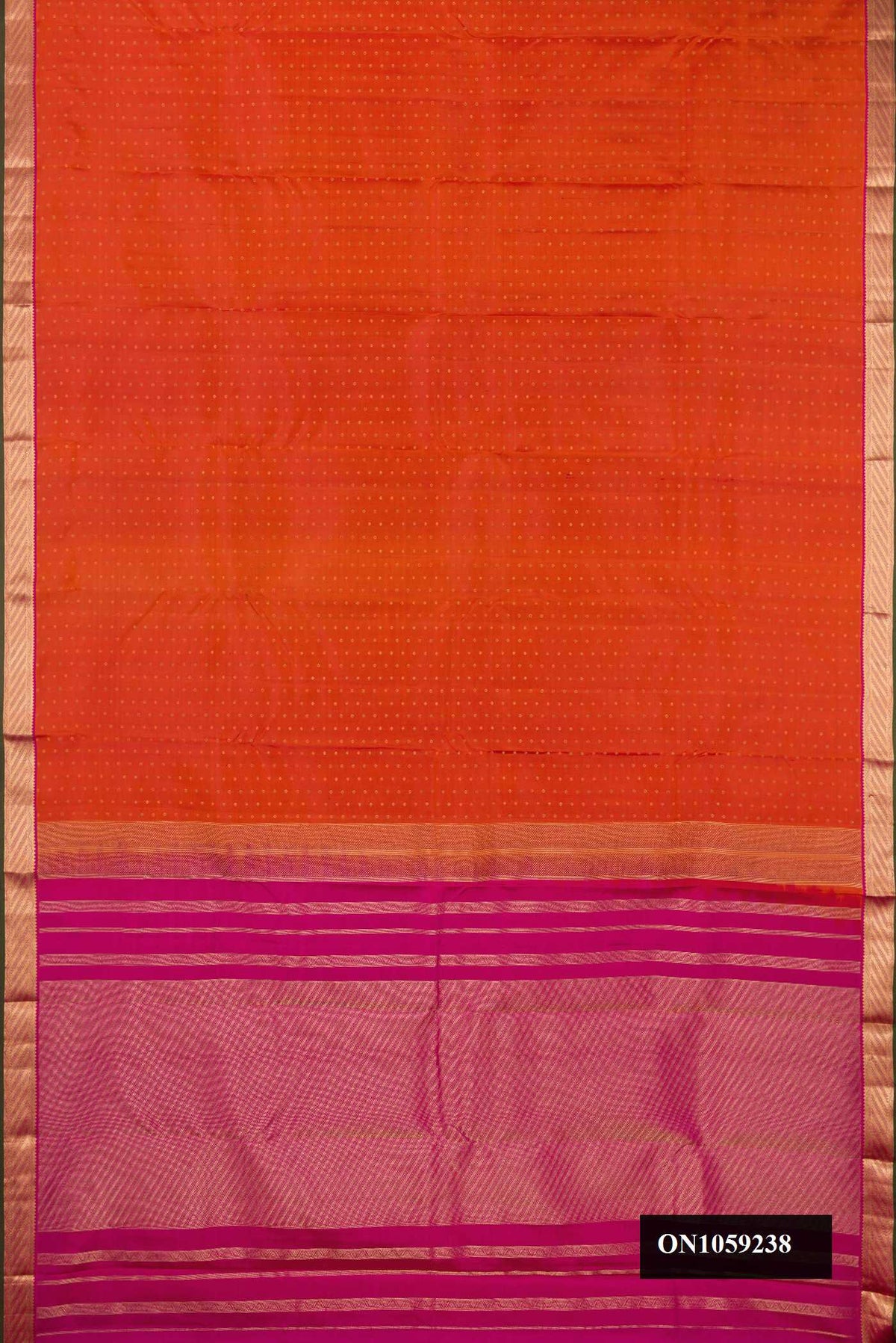 Brick Orange Dual Tone Kanchipuram Silk Saree with Zari Butta on the body and Zari Border.  displayed on a mannequin