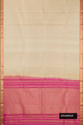 Beige Dual Tone Kanchipuram Silk Saree with Zari Butta on the body and Zari Border.  displayed on a mannequin