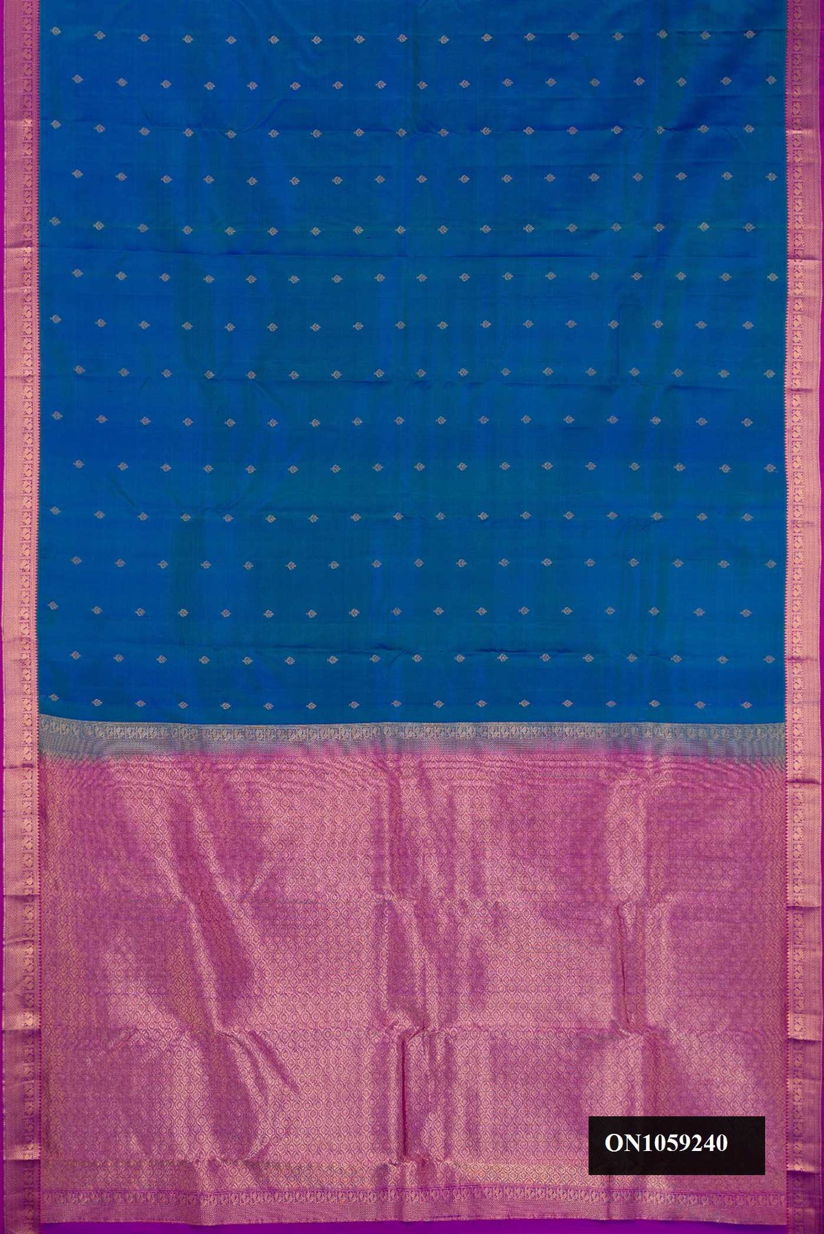 Peacock Blue Dual Tone Kanchipuram Silk Saree with Zari Butta on the body and Zari Border.  displayed on a mannequin
