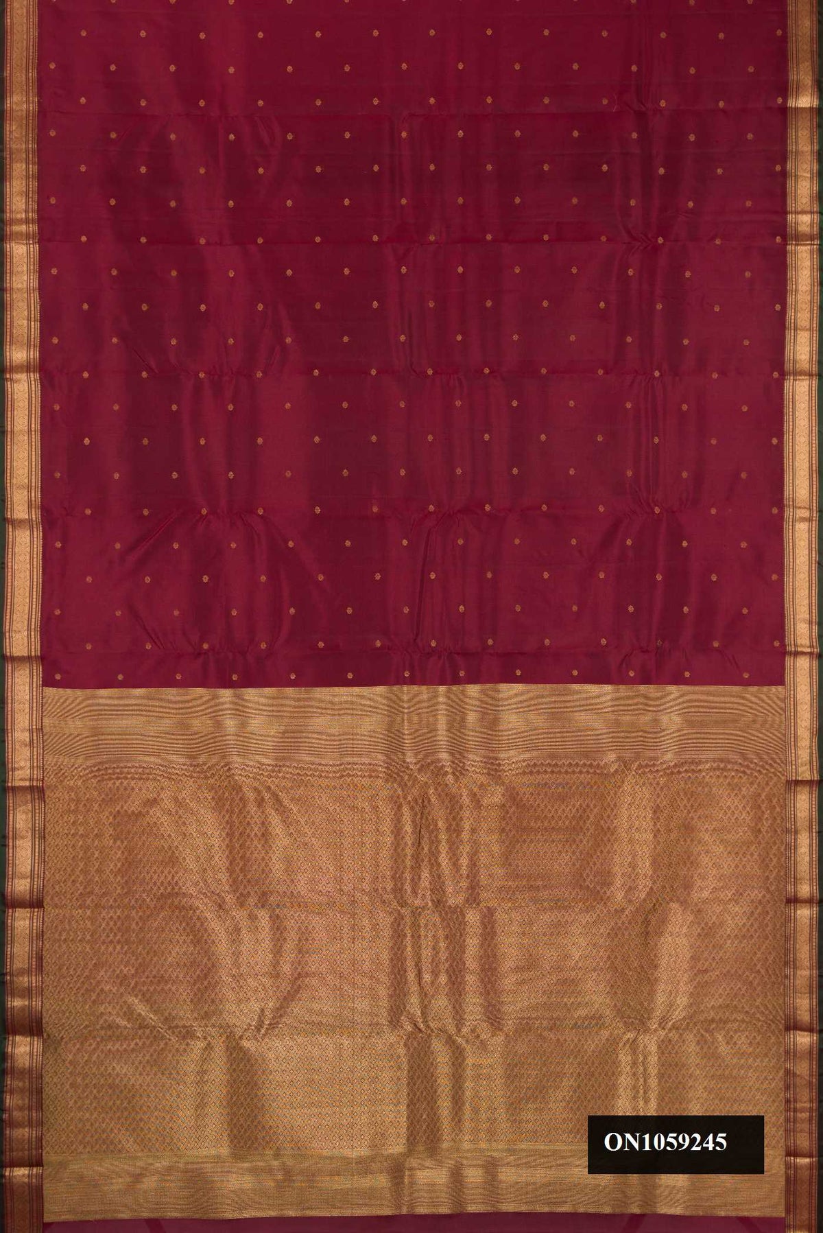 Maroon Dual Tone Kanchipuram Silk Saree with Zari Butta on the body and Zari Border.  displayed on a mannequin